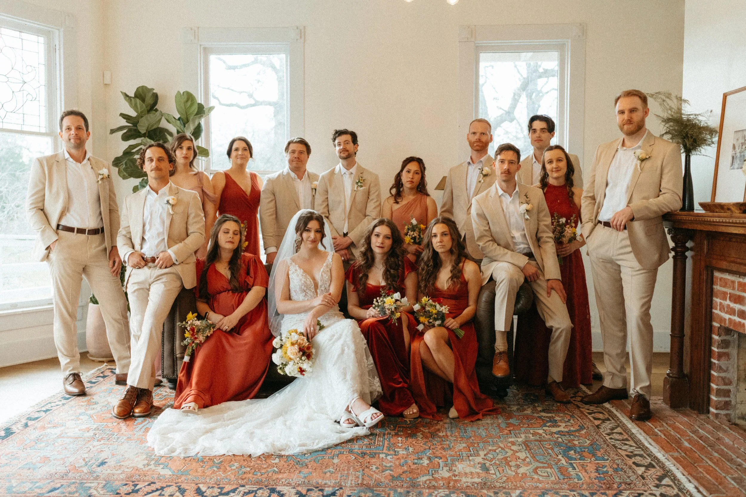 Vogue-style wedding party group photo inside The Grand Lady mansion living room
