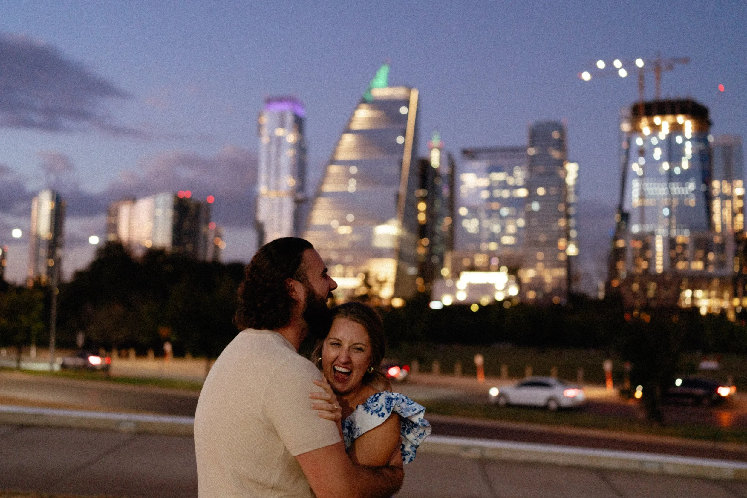 Bride-to-be surprised during proposal at Auditorium Shores with Austin skyline