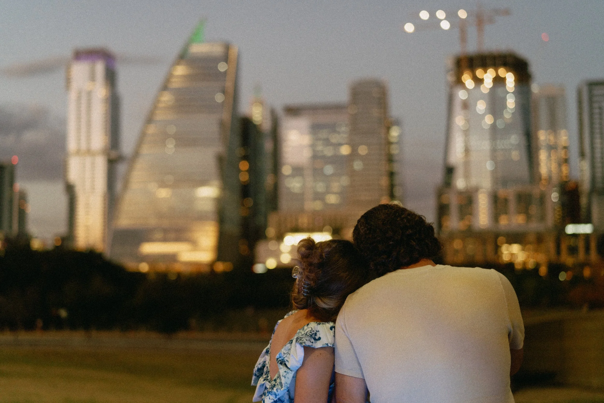 Bride-to-be surprised during proposal at Auditorium Shores with Austin skyline
