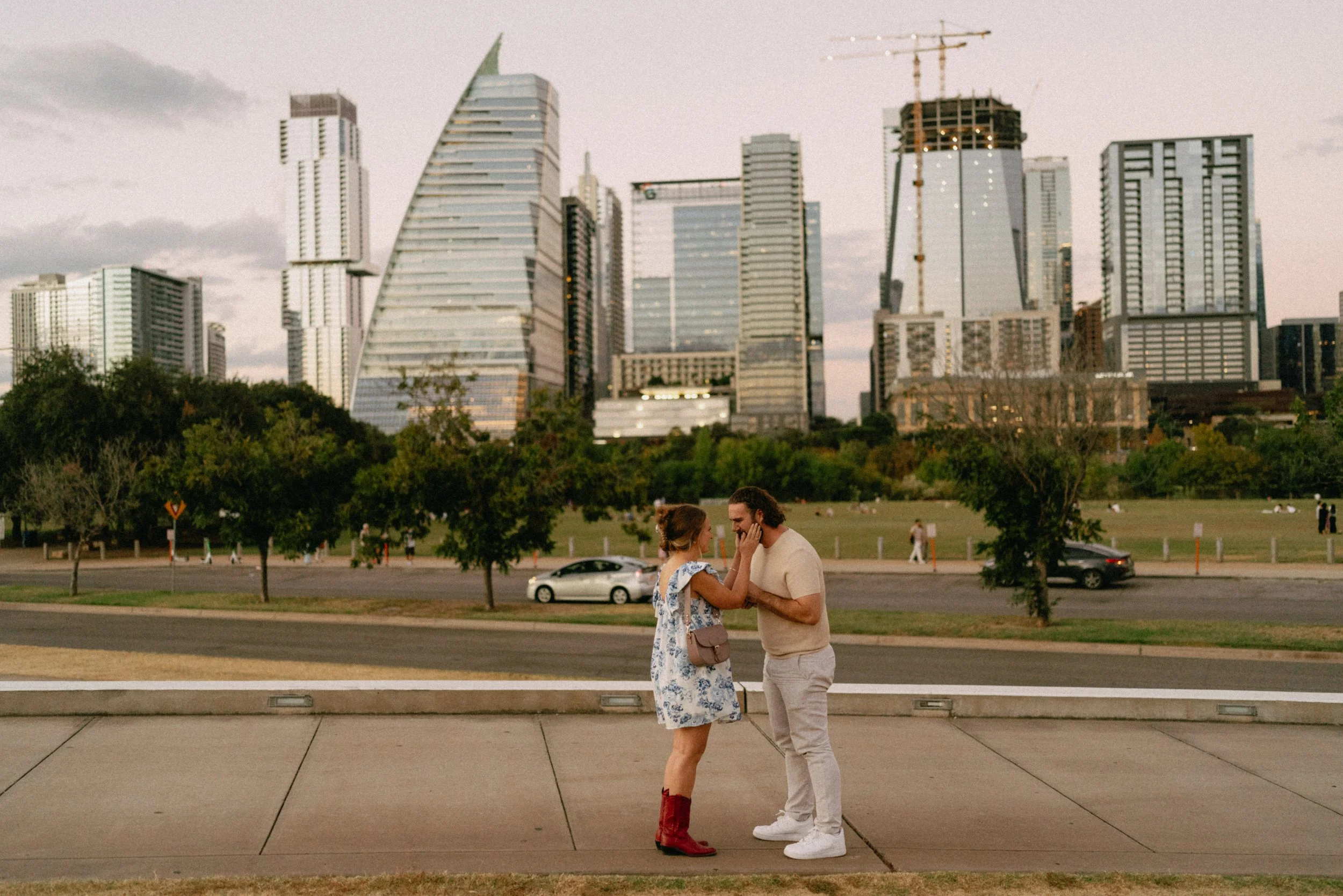 Groom proposing with downtown Austin skyline glowing in the background