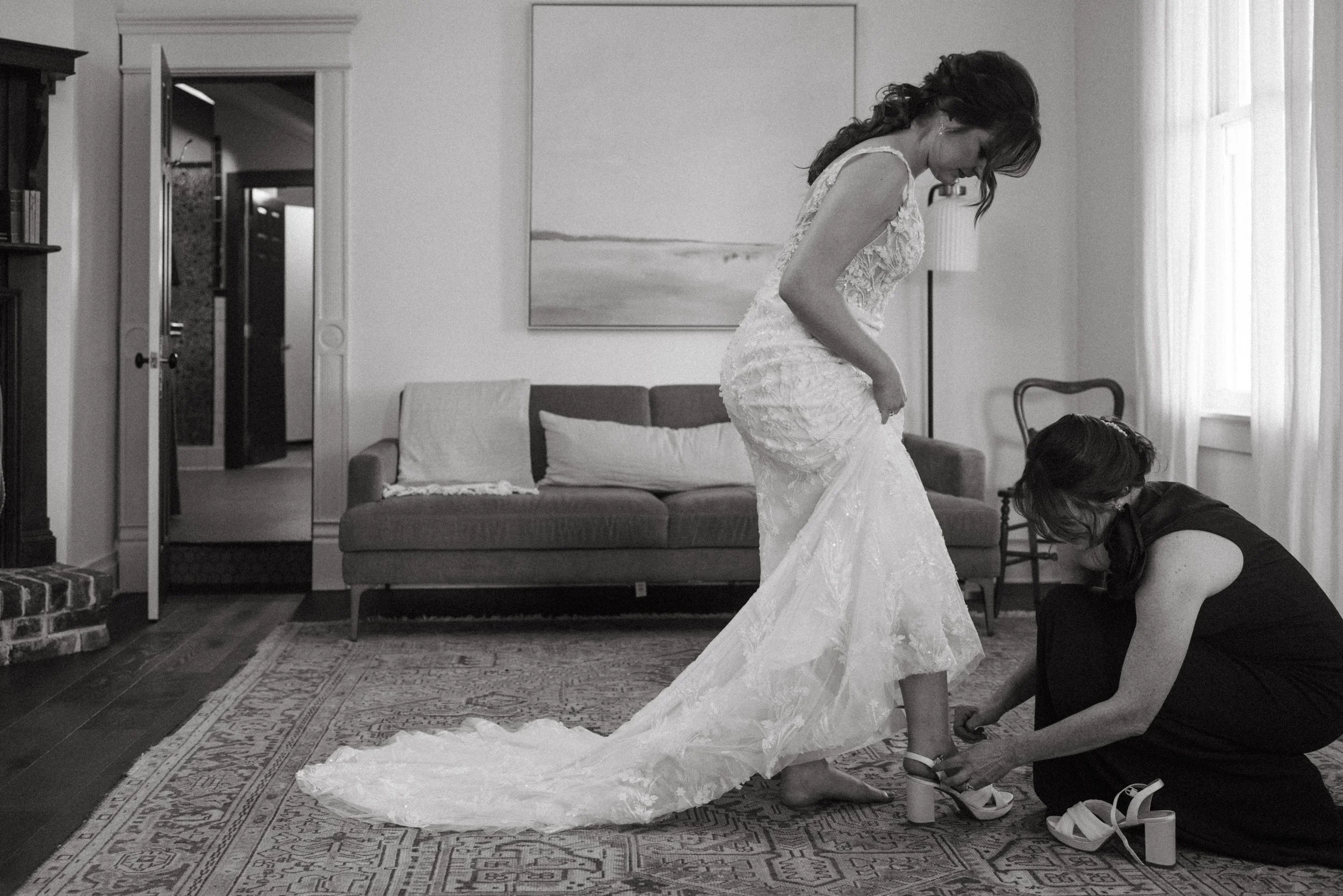 Mother of the Bride getting helping bride get into her bridal gown in mansion suite at The Grand Lady in manor tx just outside of austin