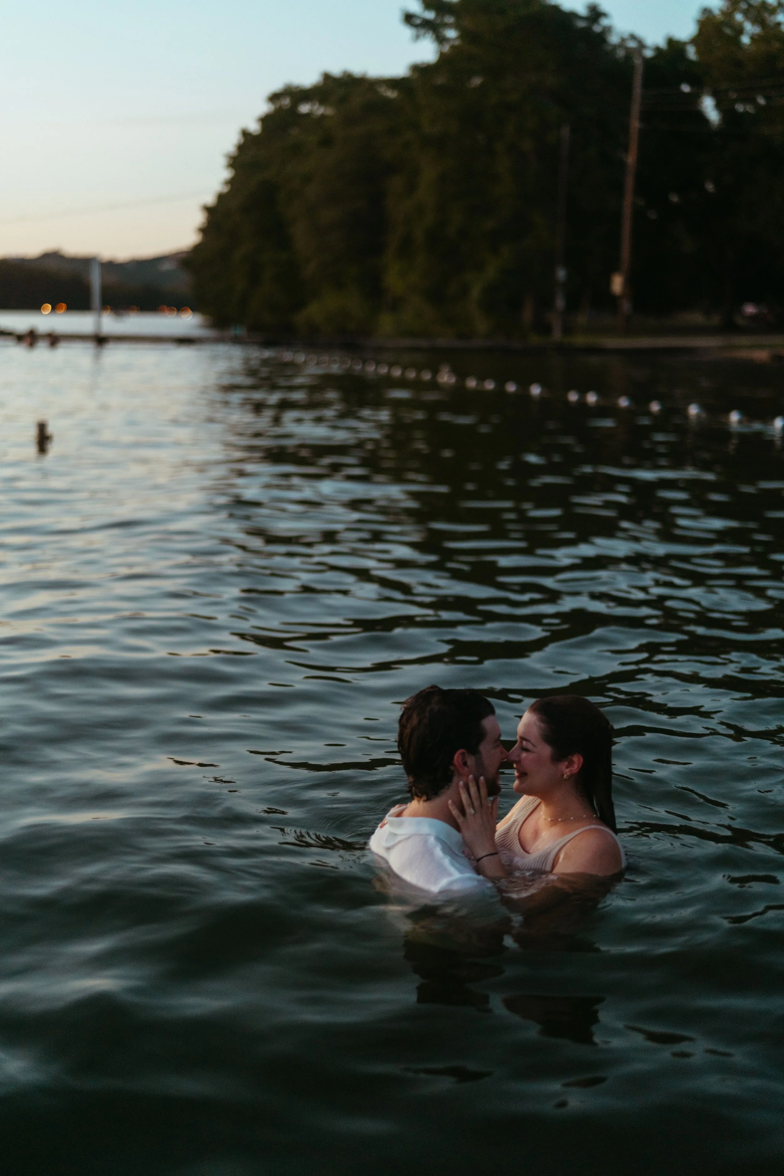Playful Austin engagement photography with couple celebrating in the water