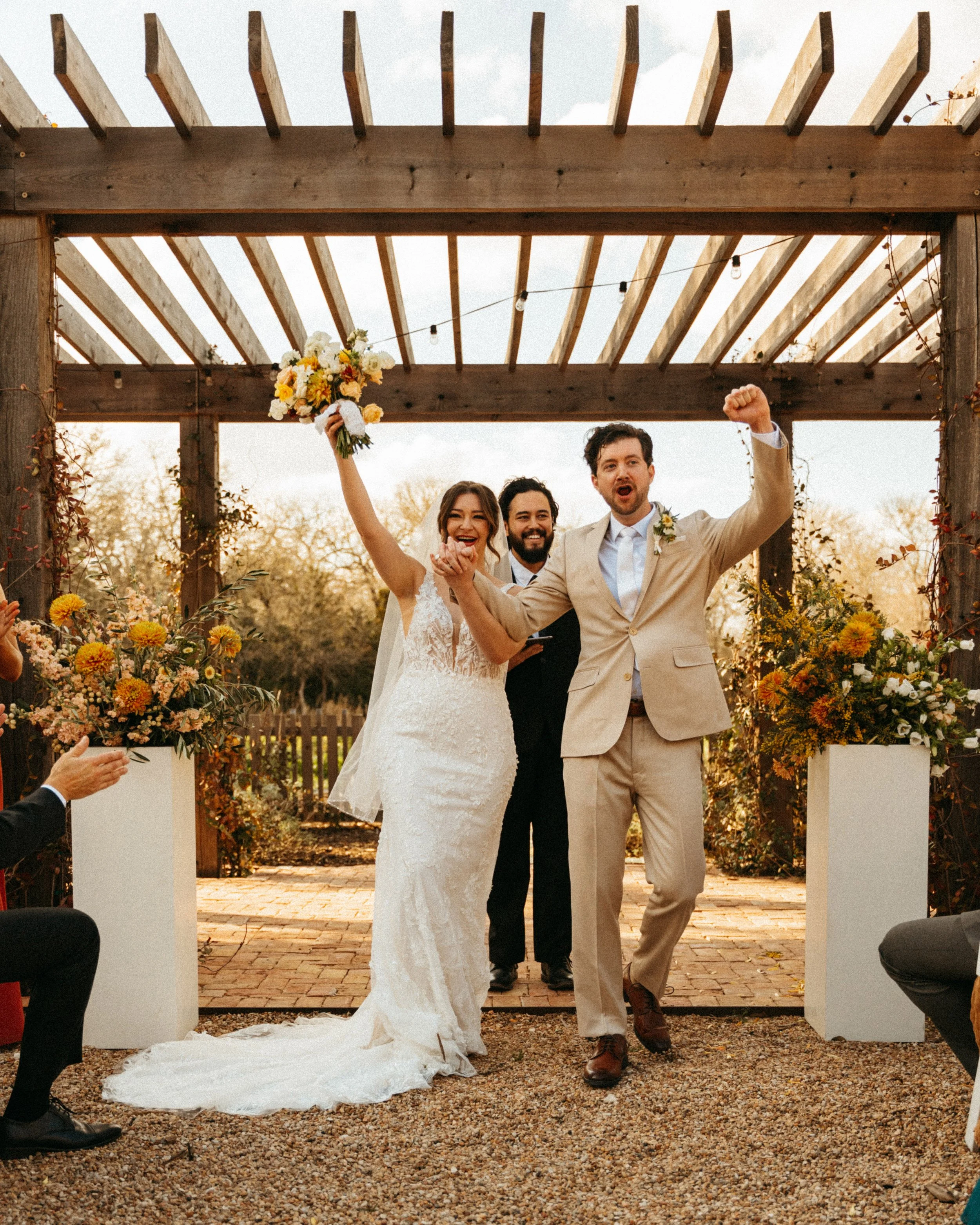 Bride and groom recess out of their flower garden wedding ceremony at The Grand Lady