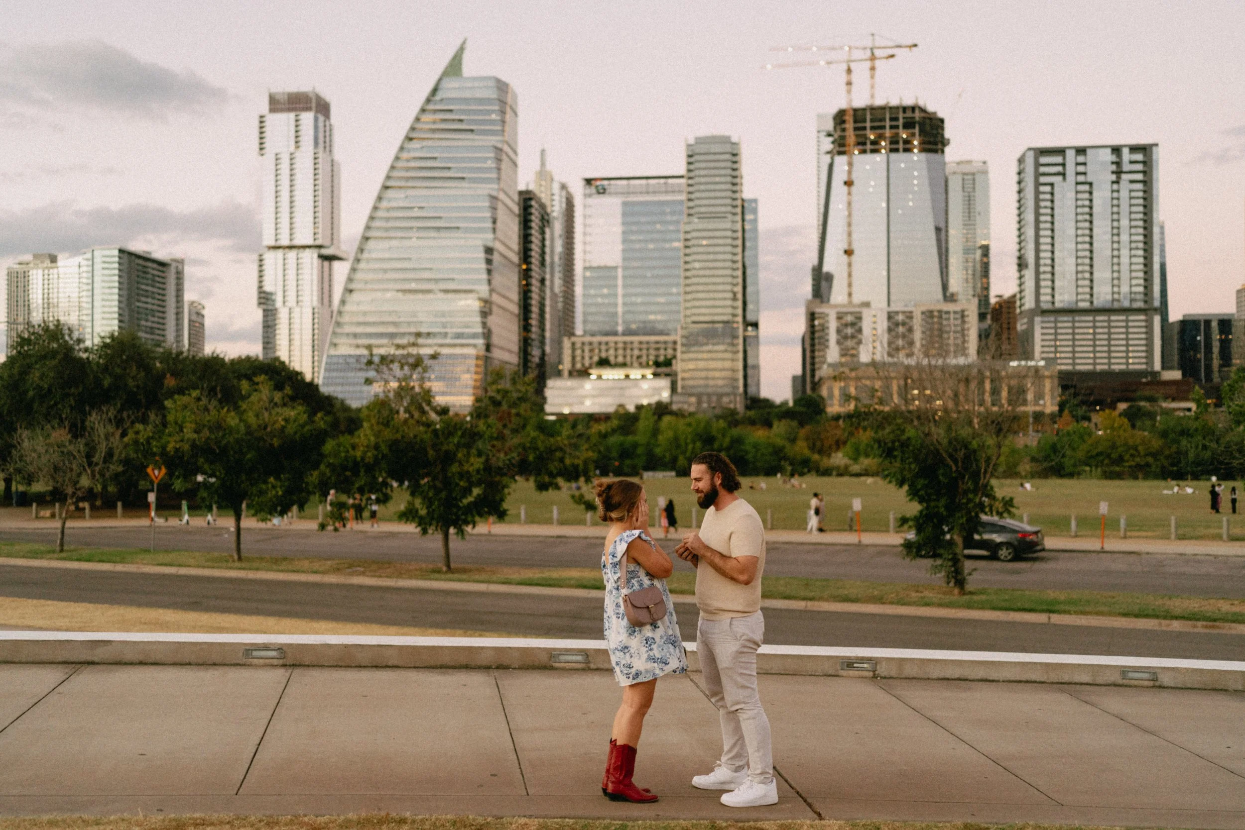 Groom proposing with downtown Austin skyline glowing in the background