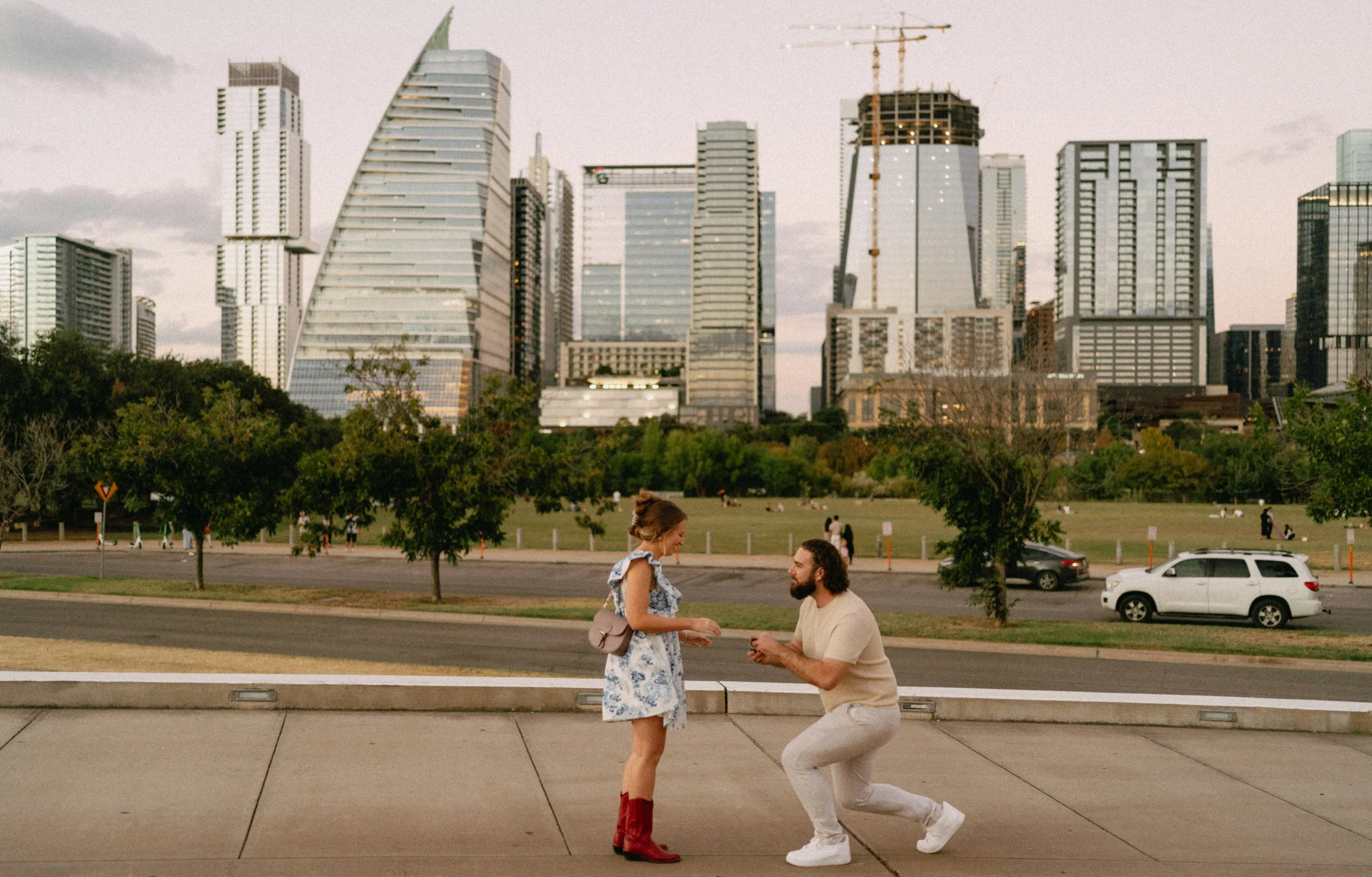 Romantic Austin proposal at Auditorium Shores with skyline at sunset captured by wedding photographer