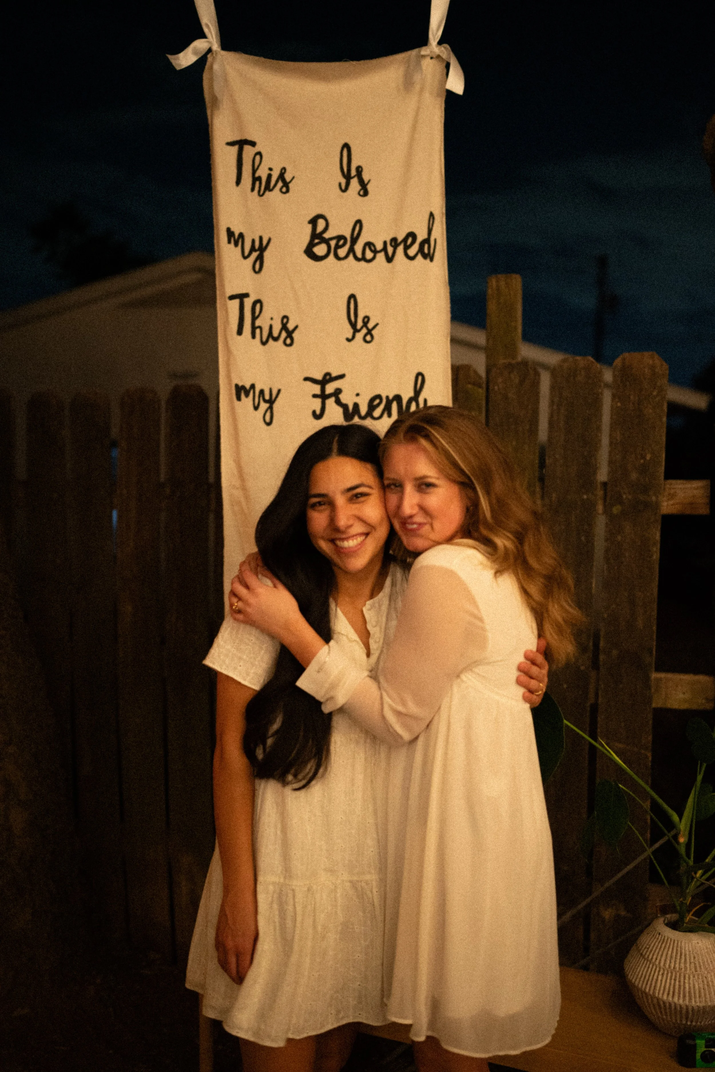 Documentary style wedding photography of couple celebrating engagement with loved ones