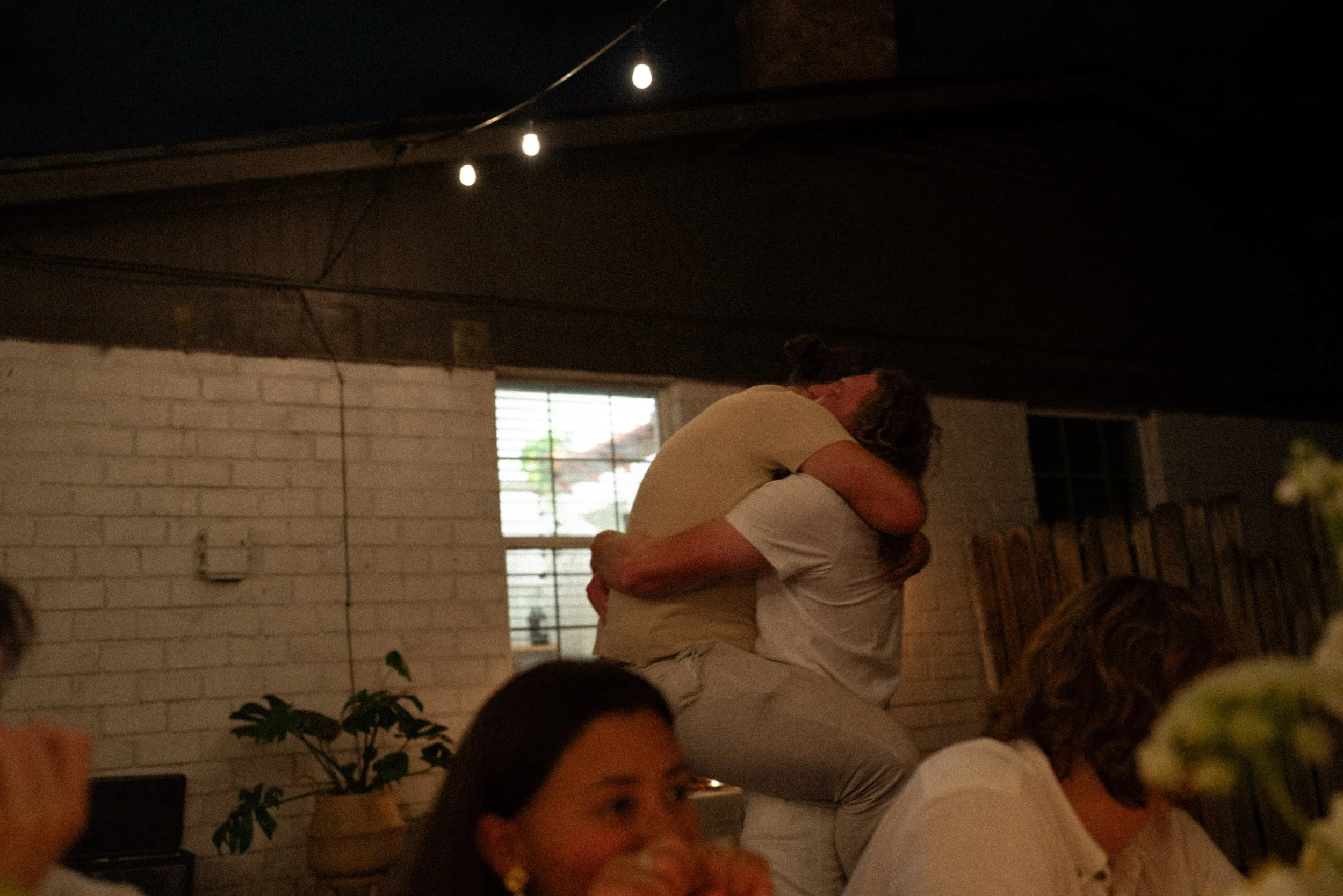 Documentary style wedding photography of couple celebrating engagement with loved ones