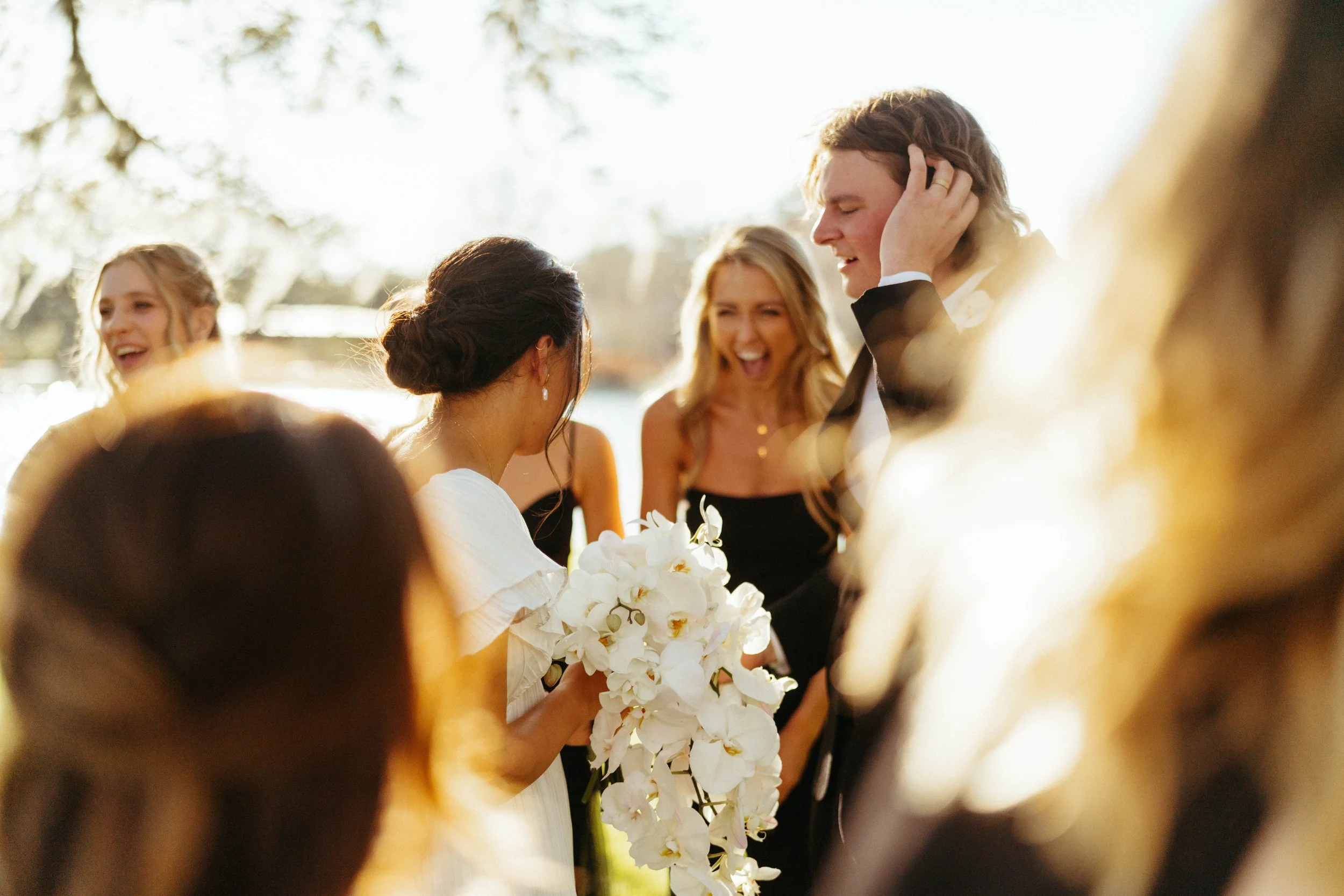 Bridesmaid sharing candid joyful moment with bride at Black Tie wedding at Houston Oaks | Austin TX travel photographer