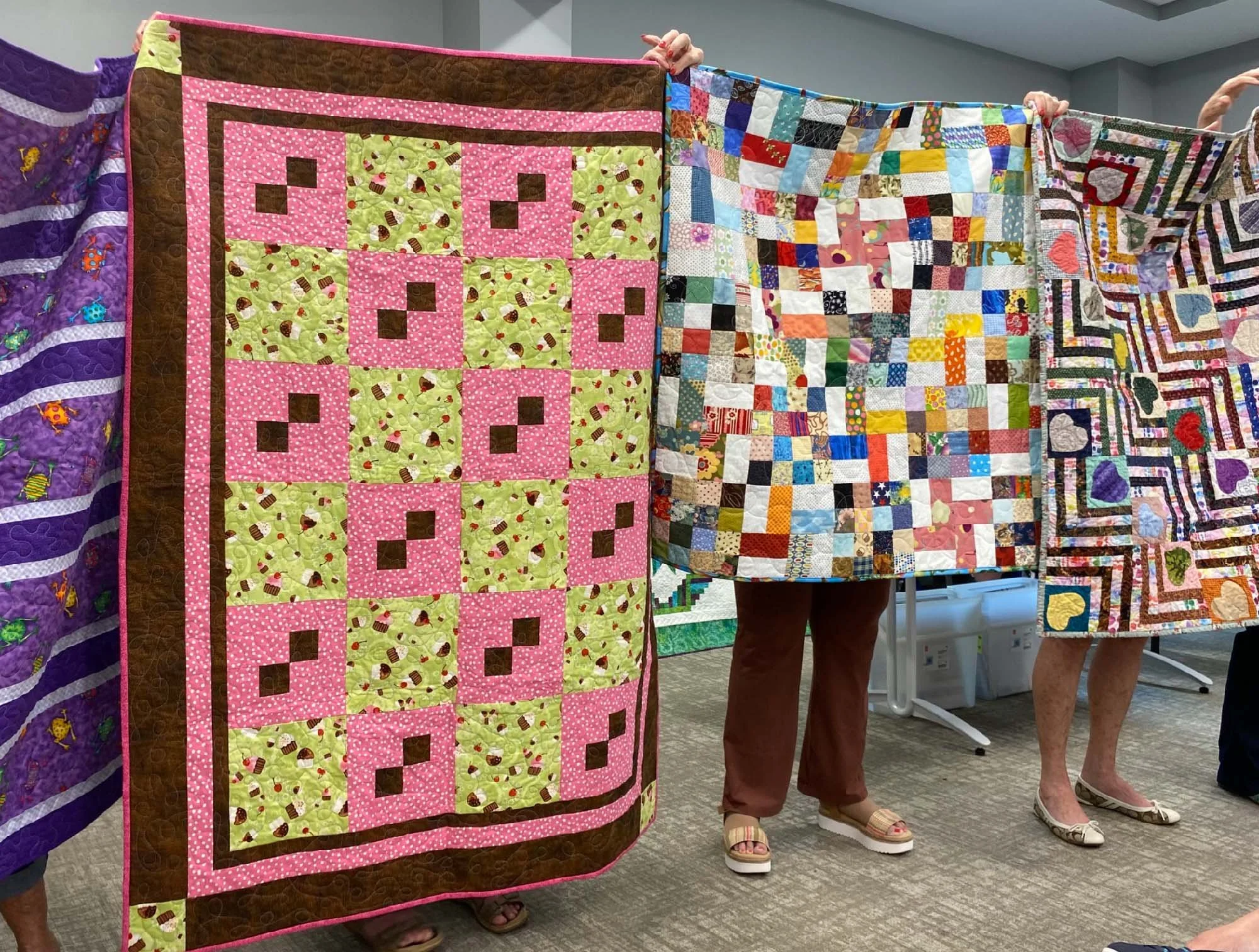 four completed comfort quilts on display
