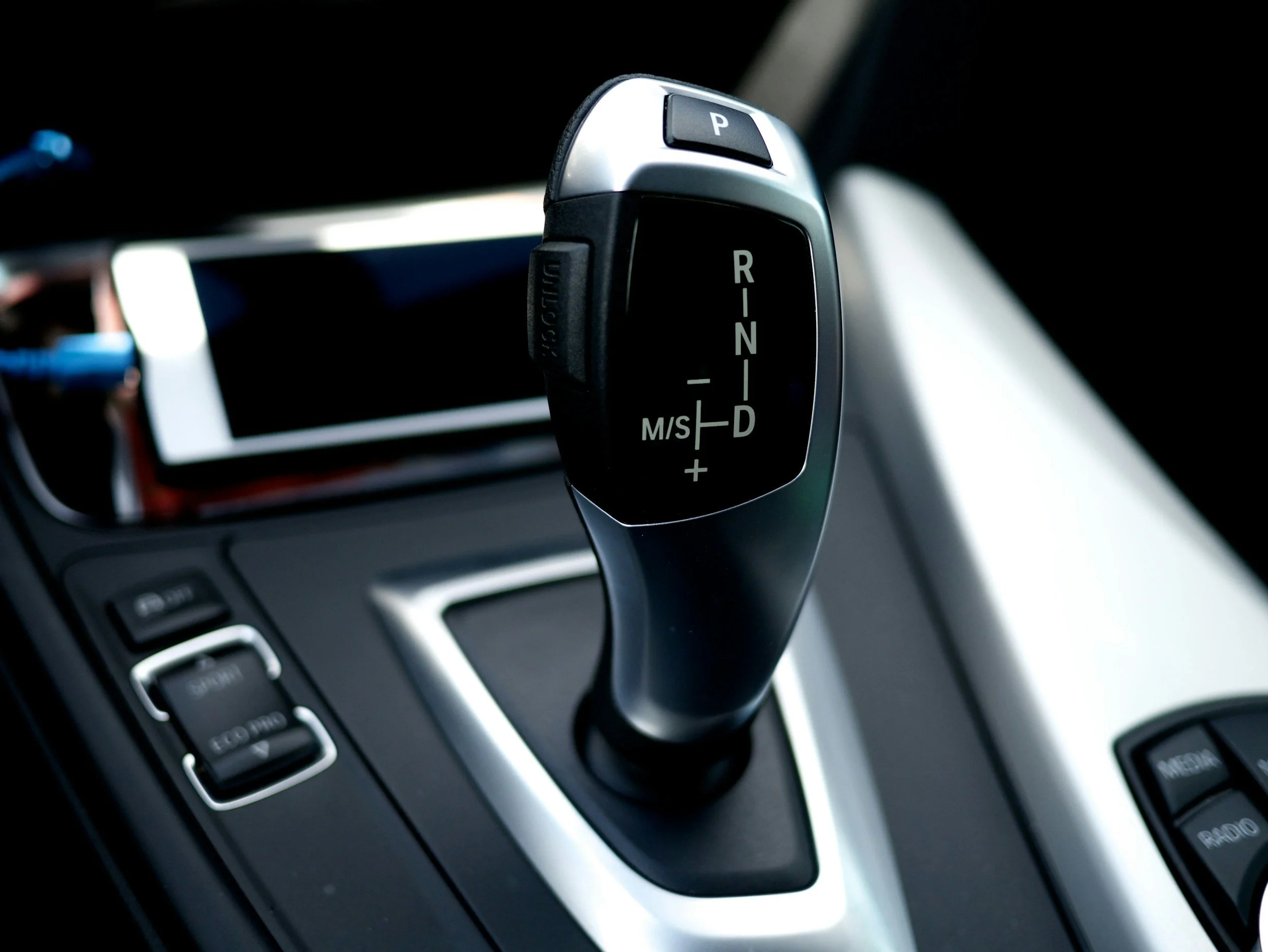 Close-up of an automatic transmission gear knob—perfect for mastering shifts in automatic car lessons.