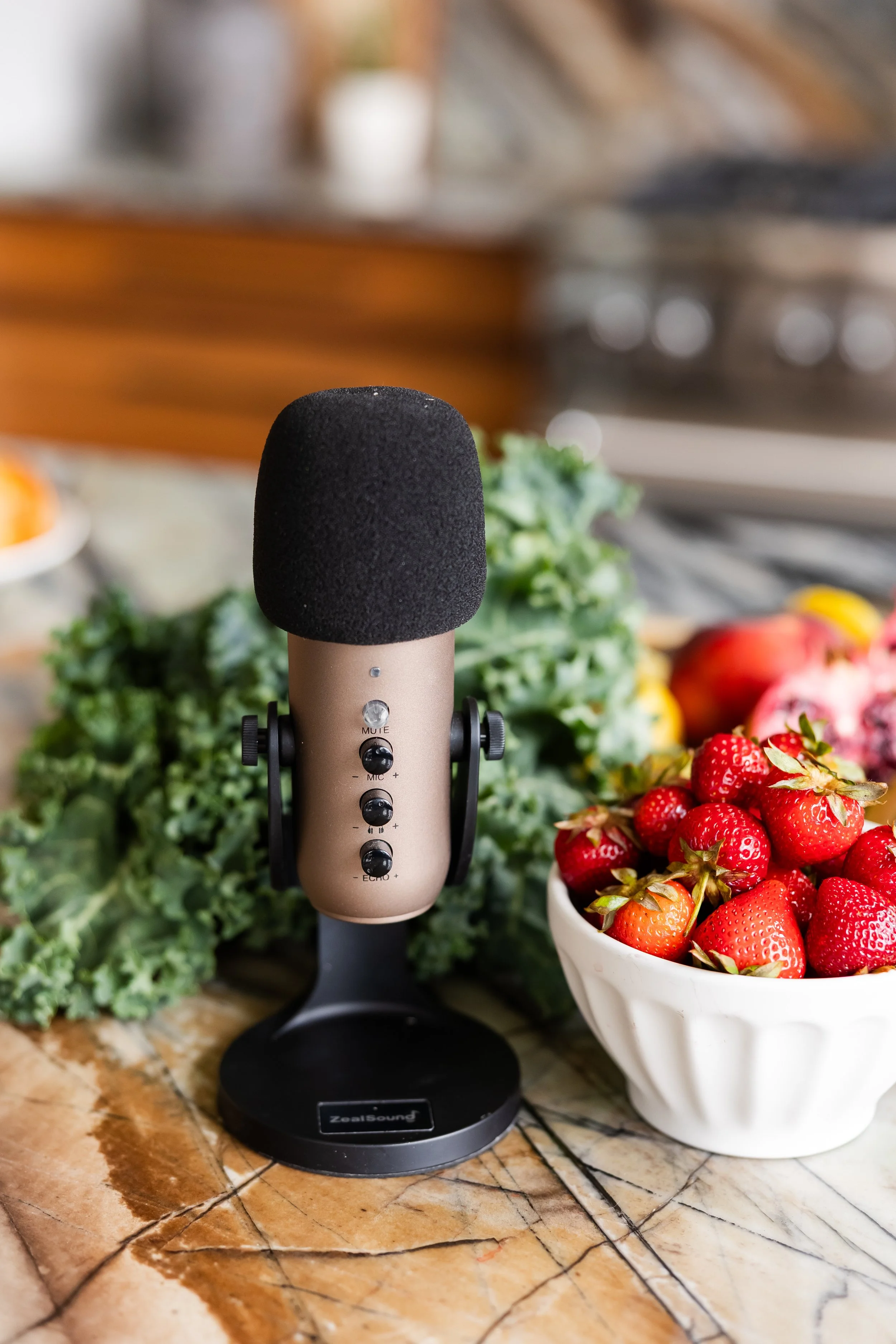 The Truth Based Nutrition podcast microphone next to a bowl of strawberries