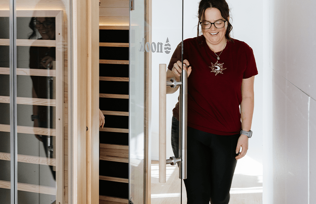 Woman opening the door of a sauna in Beerwah