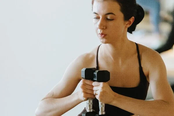 Woman doing a Pilates class with weights