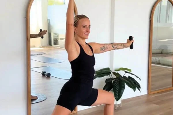 Woman doing yoga with weights during a Yoga Sculpt class on the Sunshine Coast