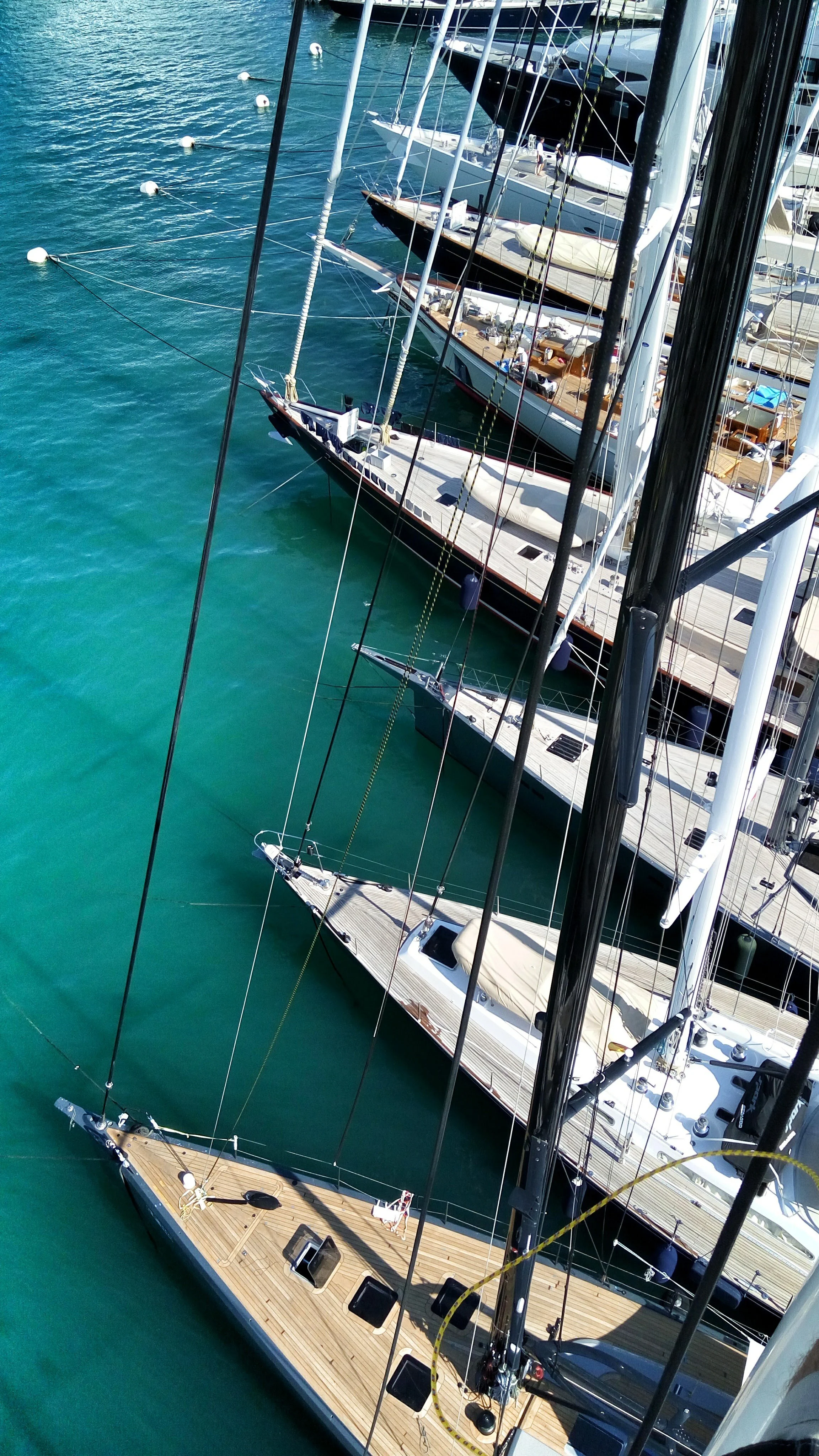 Multiple yachts docked at a marina, viewed from above