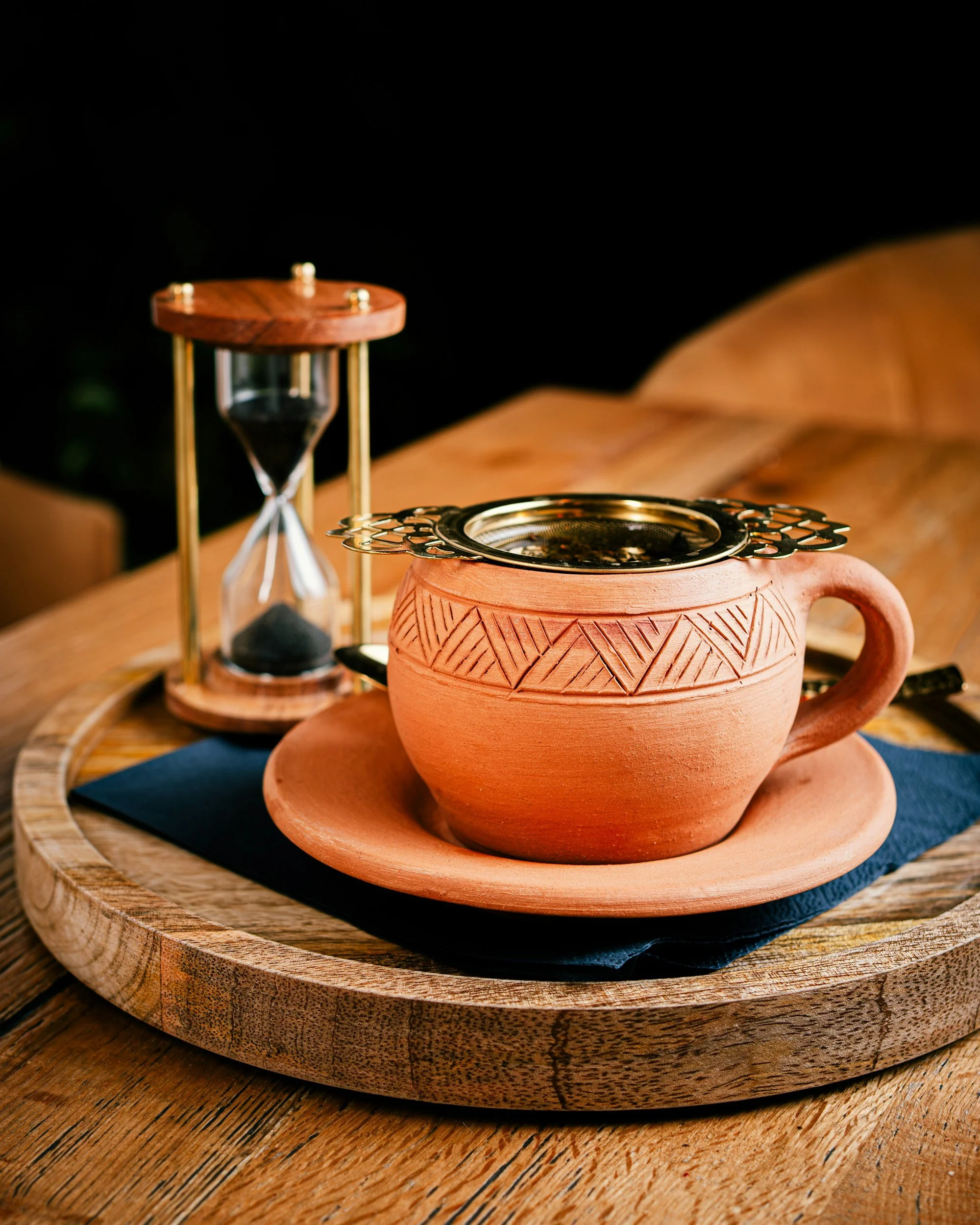 Tea cup with an hour glass.