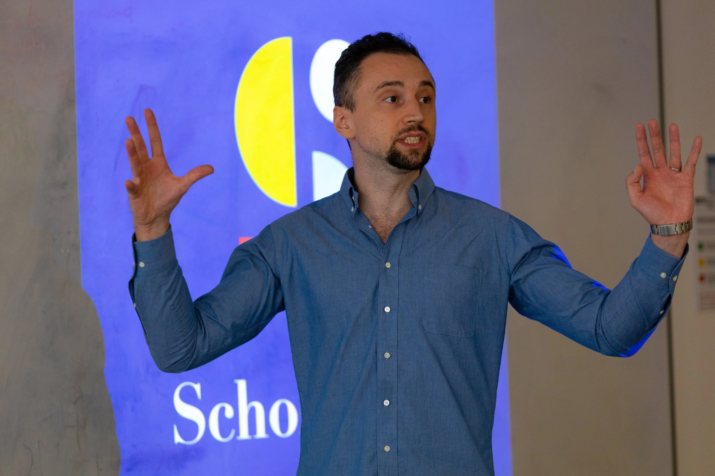schologists psychology tutor sam swidzinski talking to student in ergonomic chair with plant in background