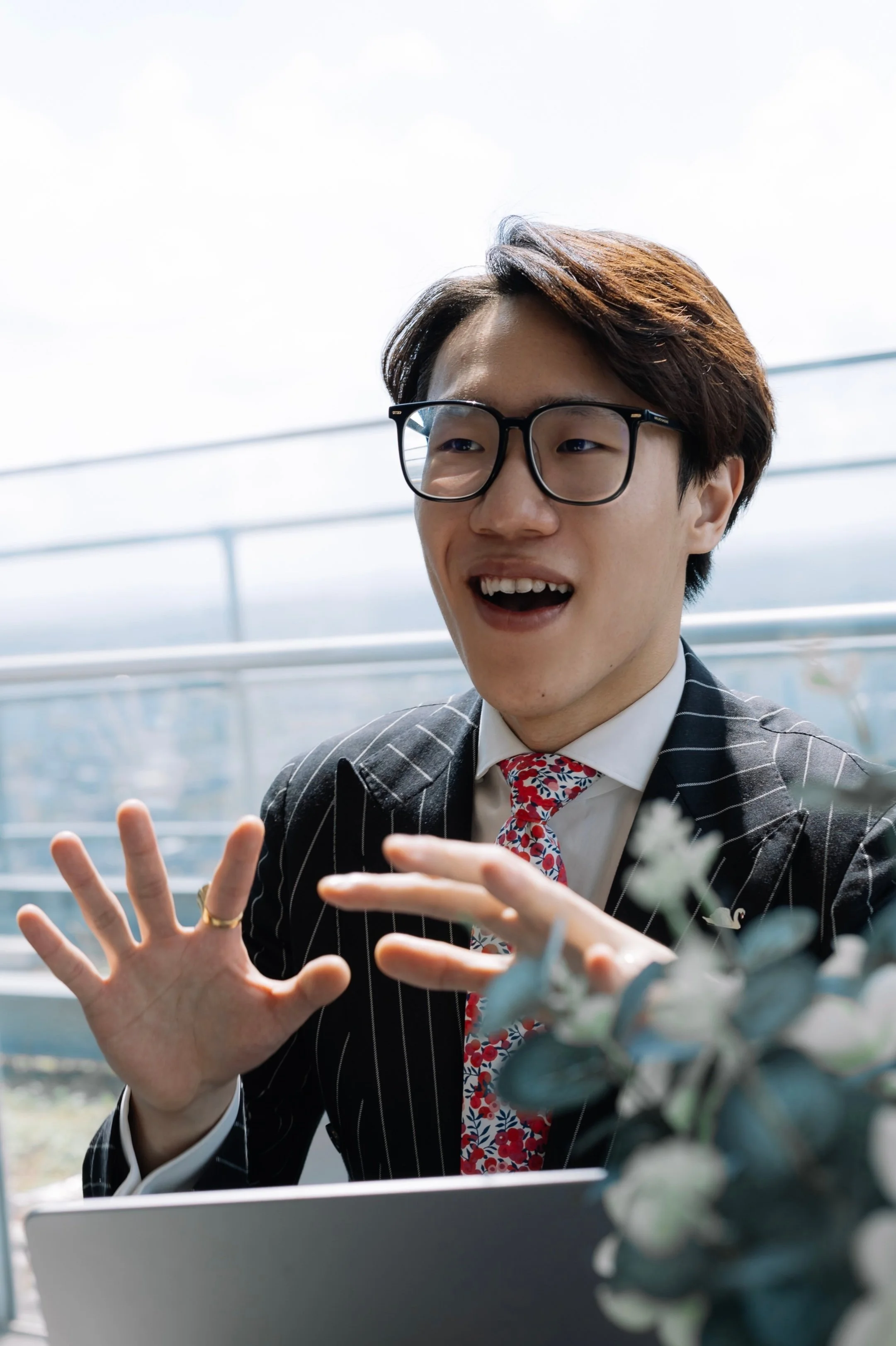 schologists chinese psychology tutor frank zheng in smart clothes with plants in background