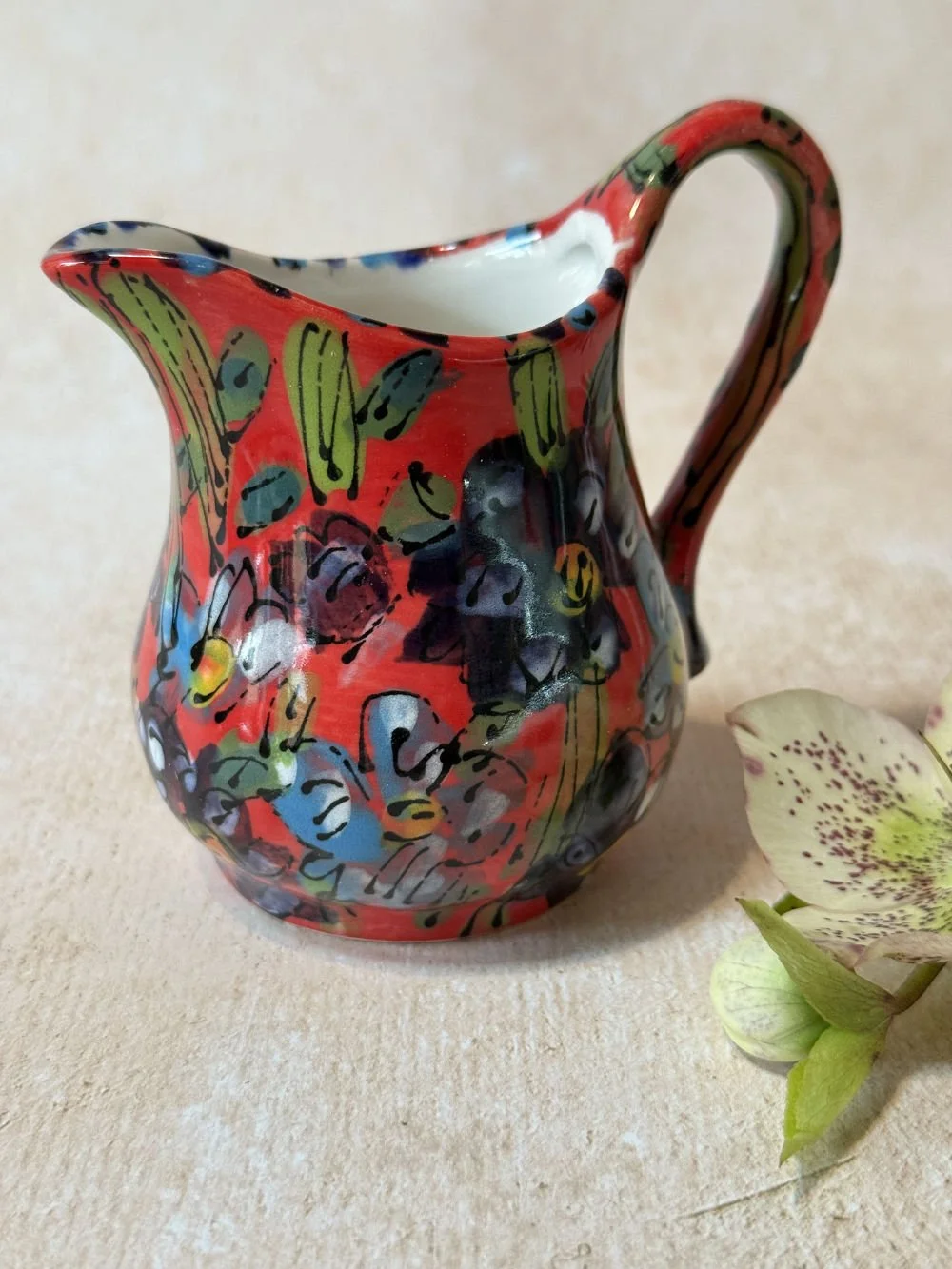 Flowers on Red Cream Jug