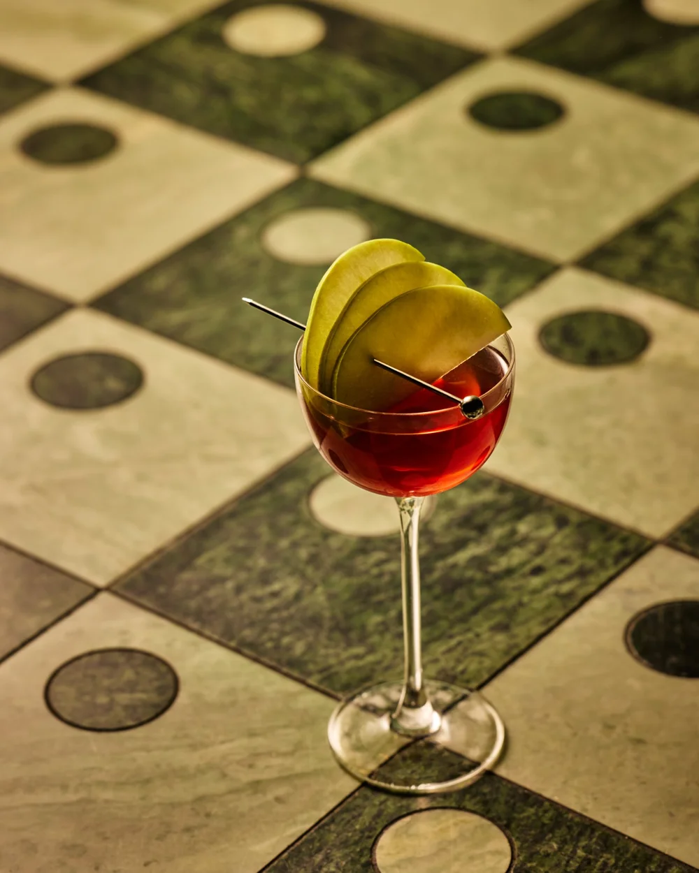 An artfully presented signature cocktail on geometric forms