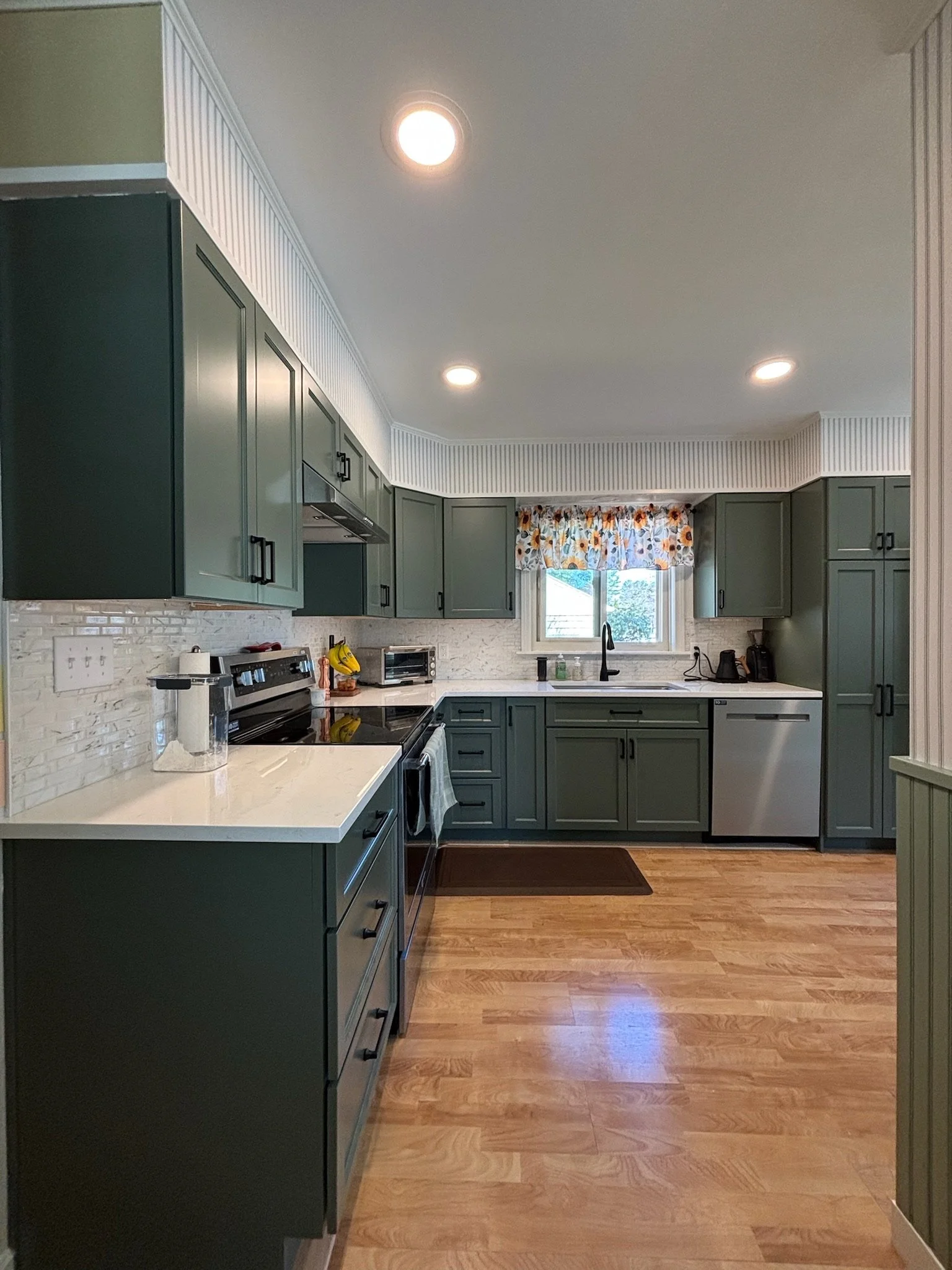 Kitchen Remodel in Portland, Maine with muted green cabinets.