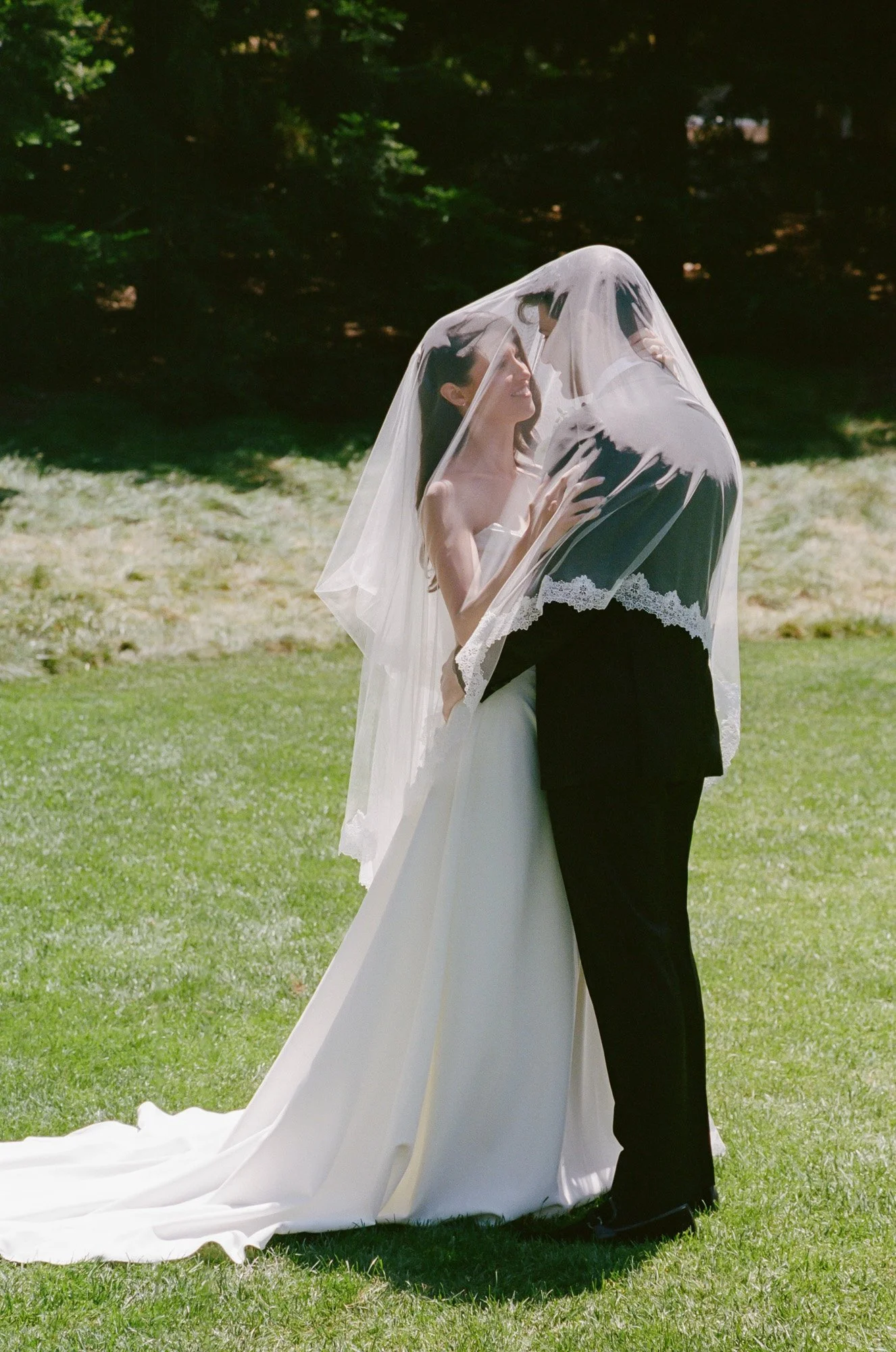 Bride and groom beneath a lace veil photographed in a timeless documentary wedding style in California