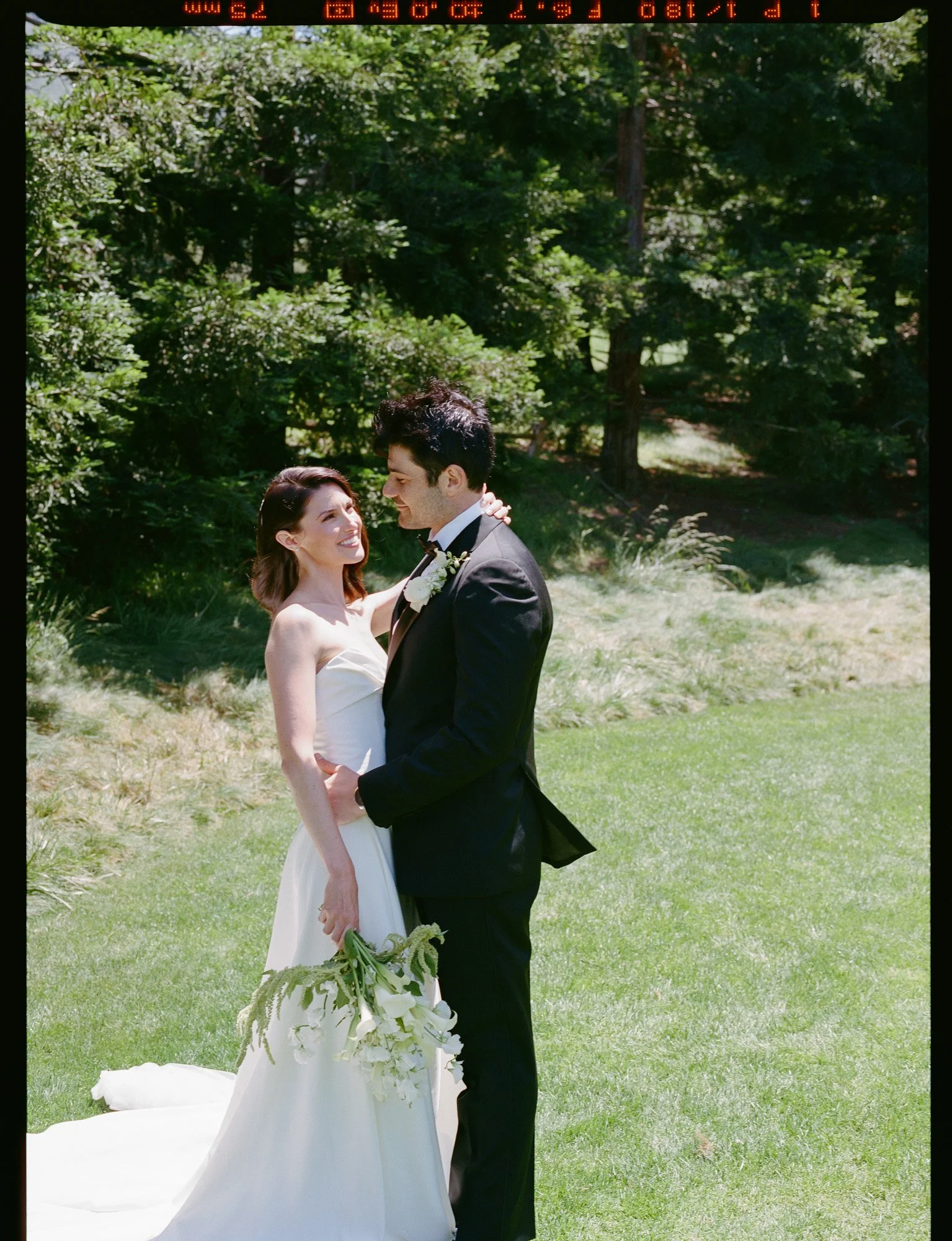 Bride and groom portrait in a sunlit garden at a California wedding captured on medium format film