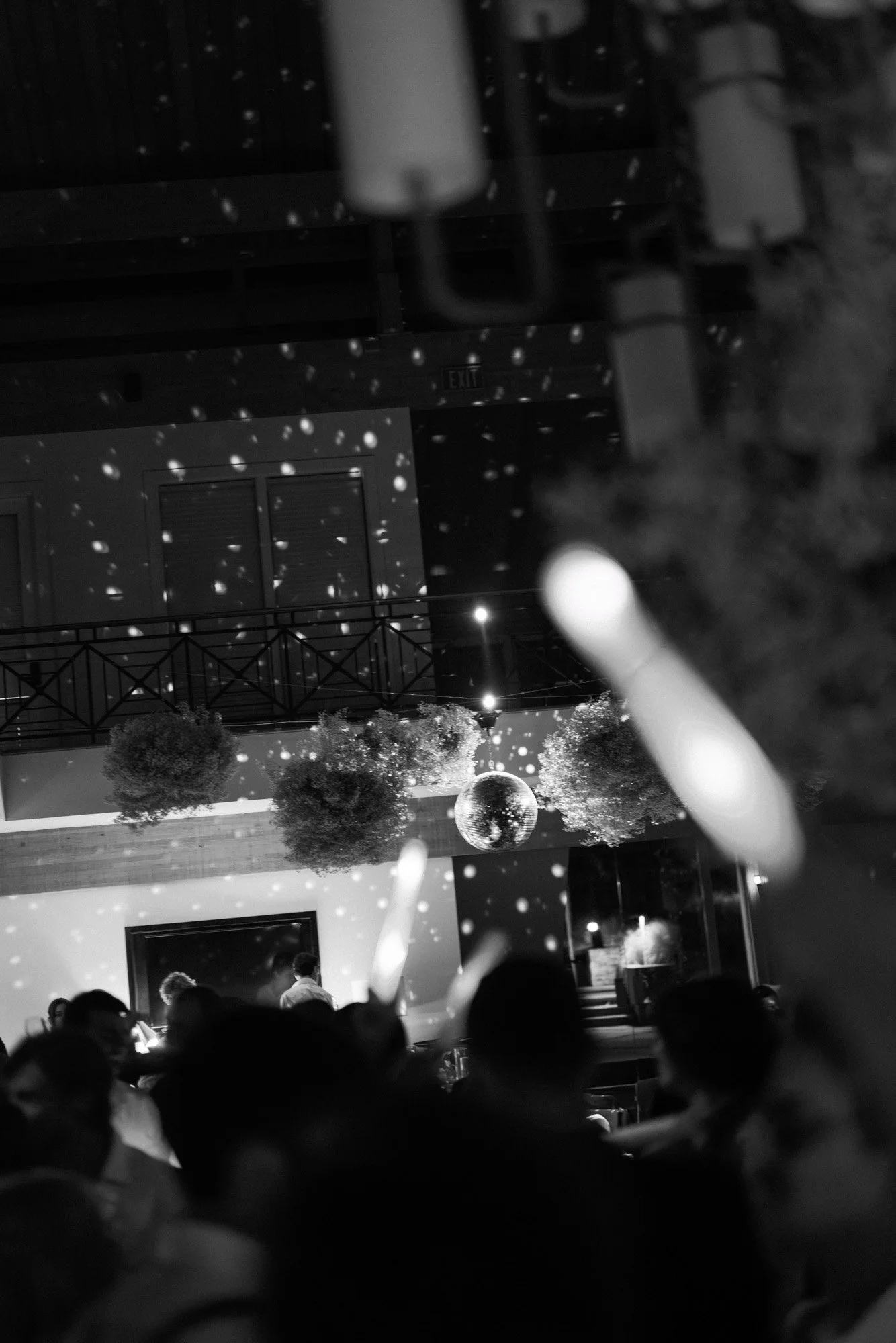 Black and white wedding reception moment with champagne and candlelight and disco balls at a Carmel Valley Ranch Wedding in California.