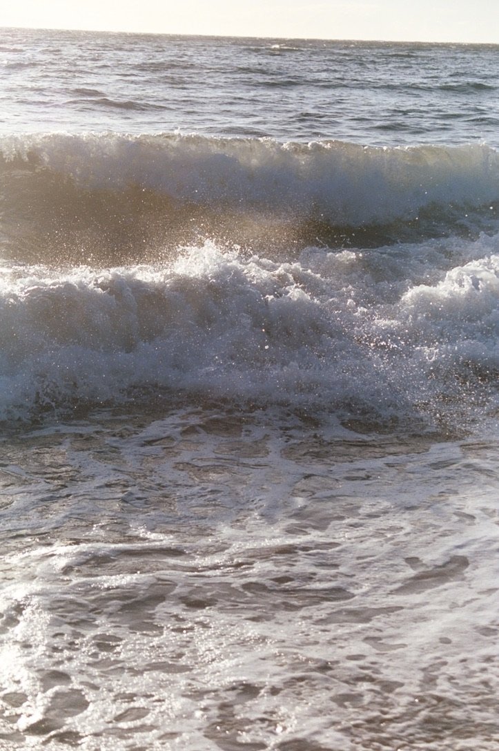 Ocean waves crashing on the shore during daytime.