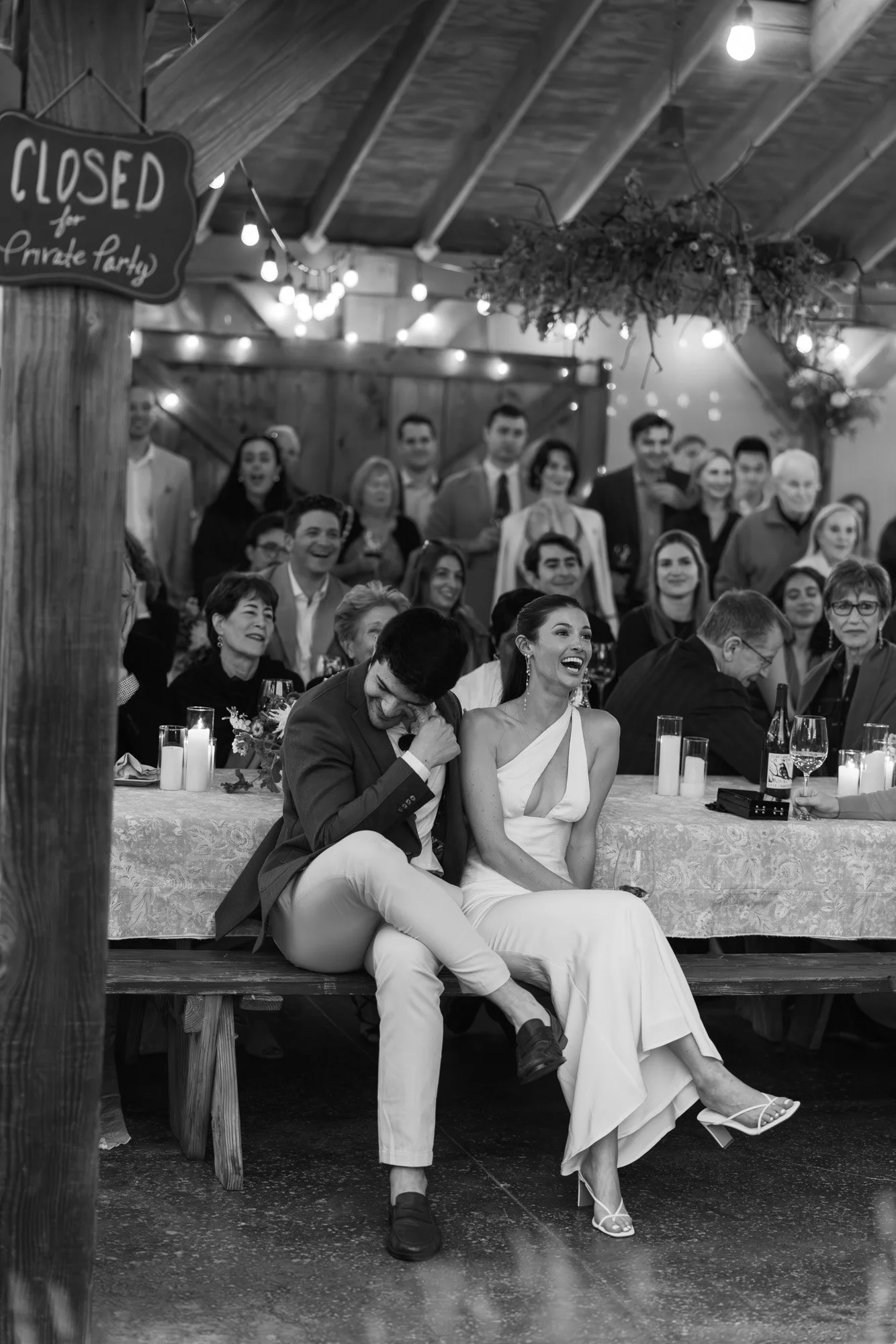 Black and white candid photo of a bride and groom at their night before rehearsal dinner,