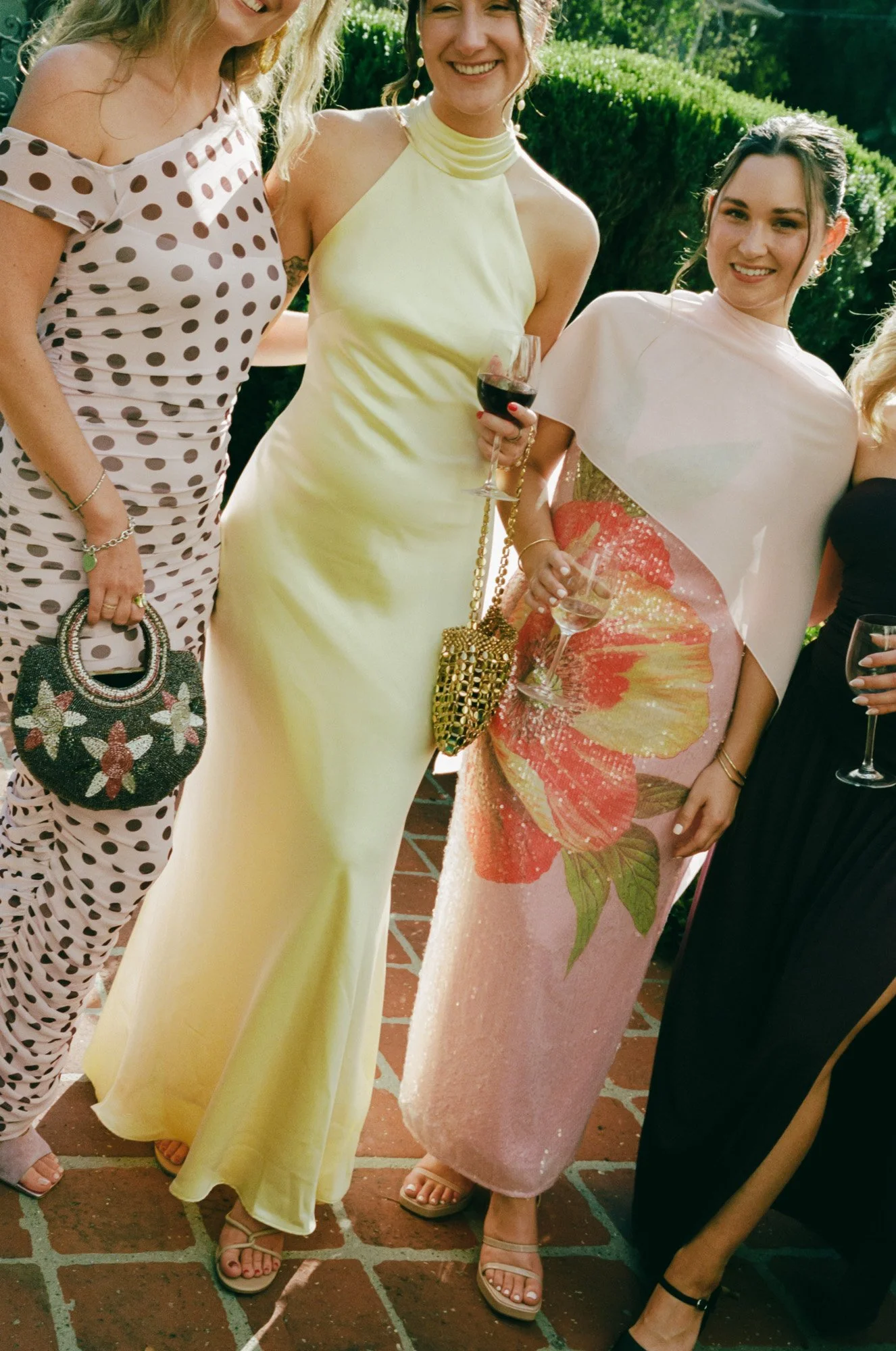 Colorful fashion-forward wedding guests carrying a patterned handbag at an editorial Santa Barbara wedding, captured on film photography.
