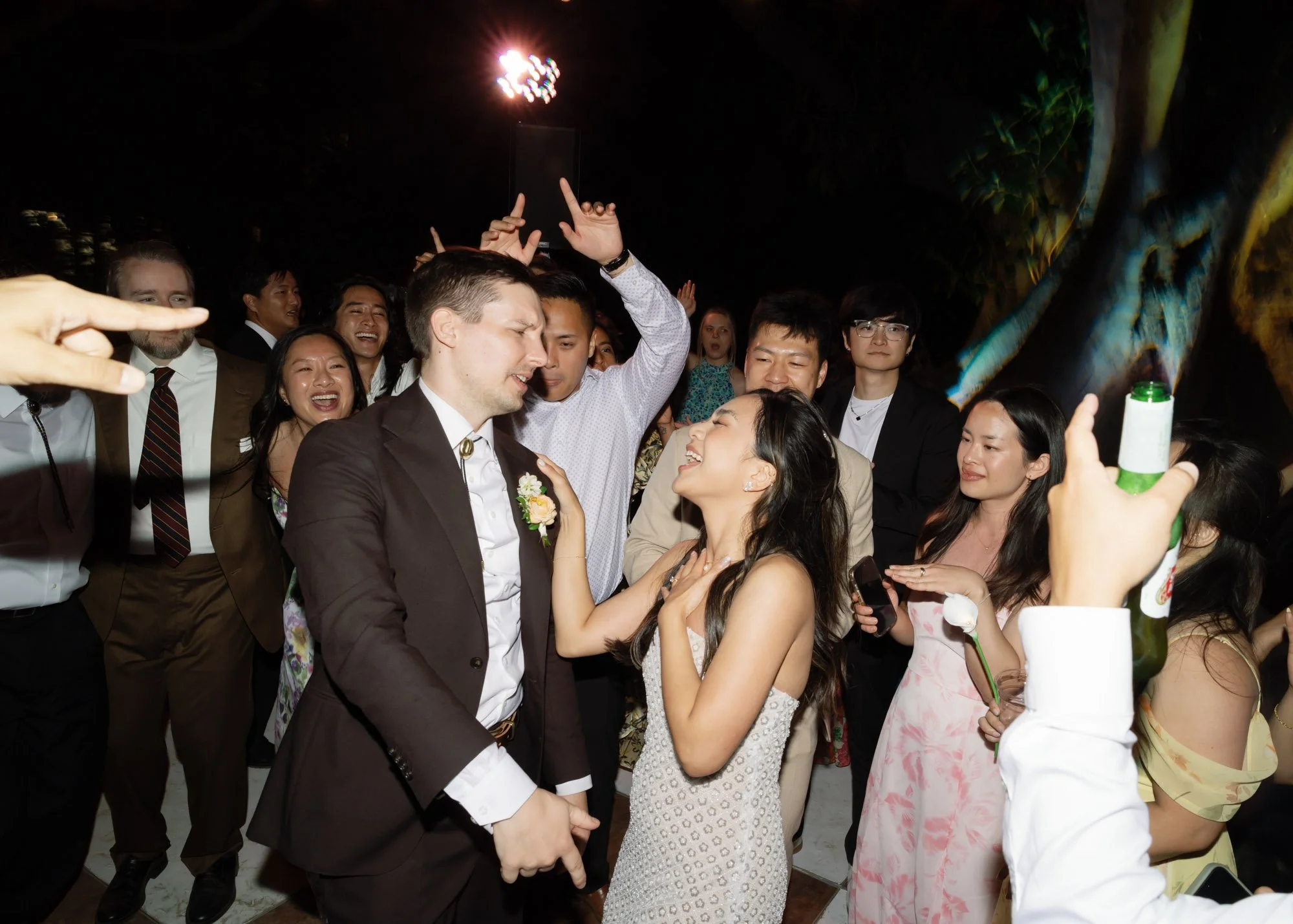 Bride and groom celebrating on the dance floor during a candid California wedding reception