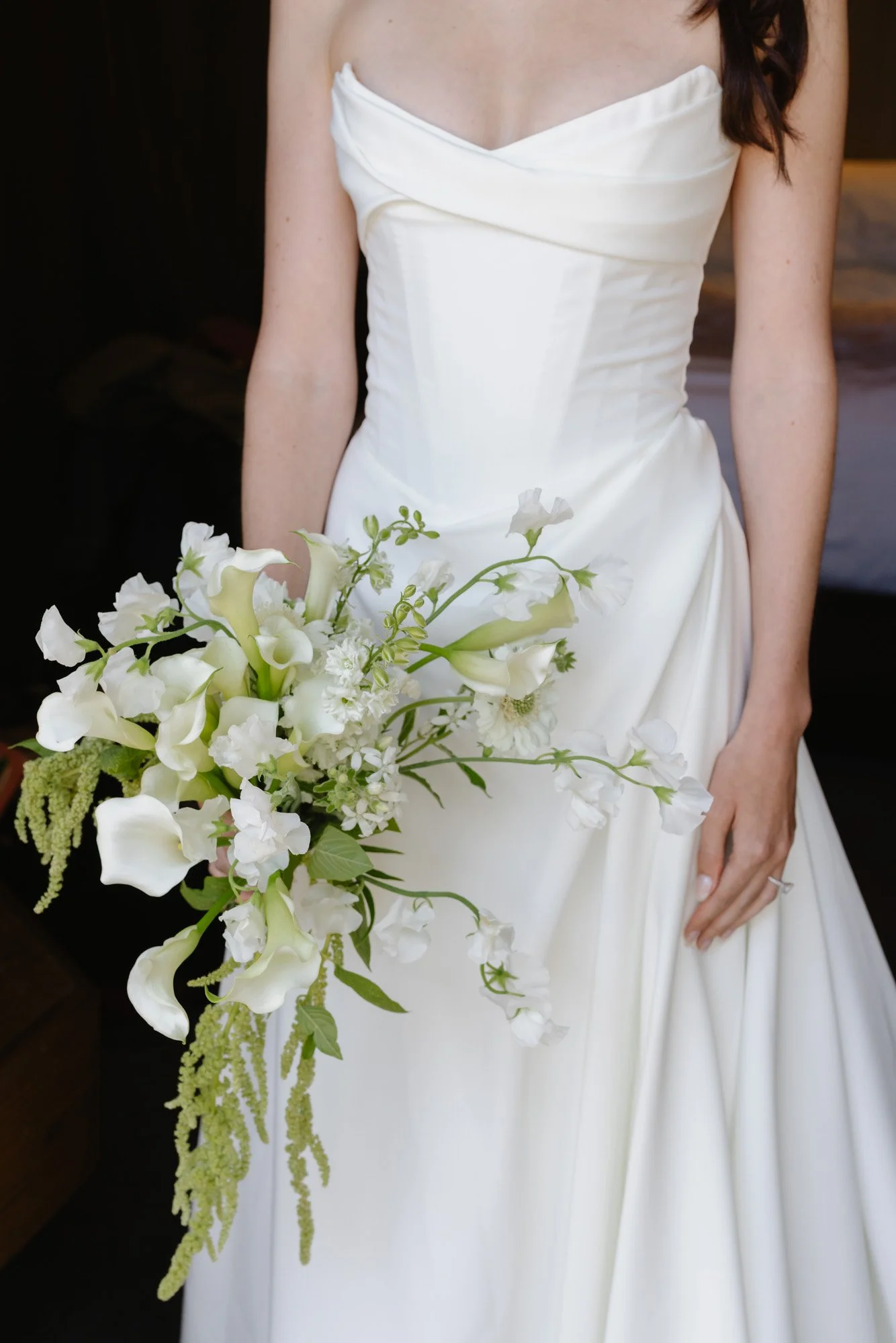 Close-up of bride holding a white calla lily bouquet in an editorial wedding portrait at a Carmel Valley Ranch Wedding