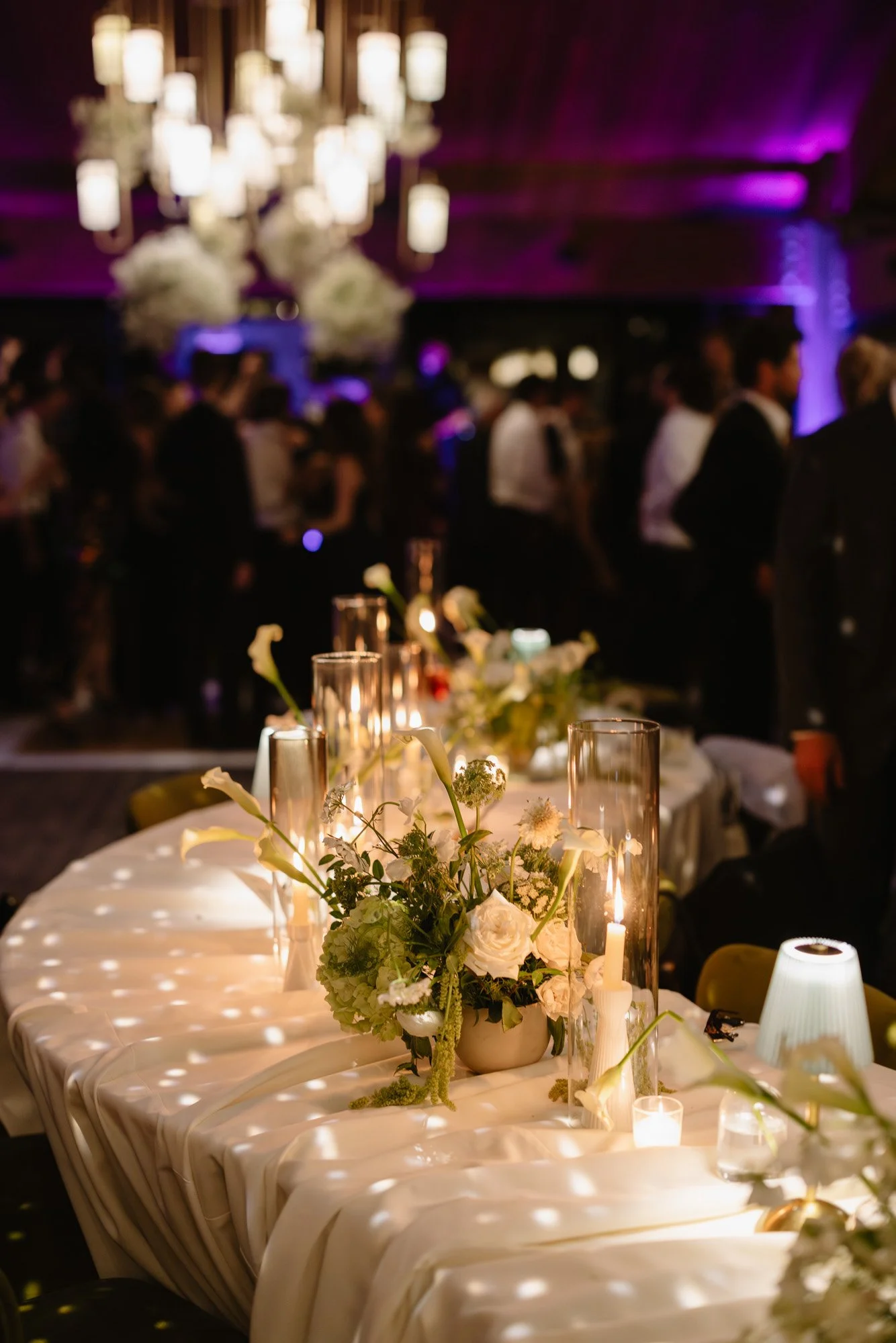 Candlelit reception table with white florals at a luxury California wedding