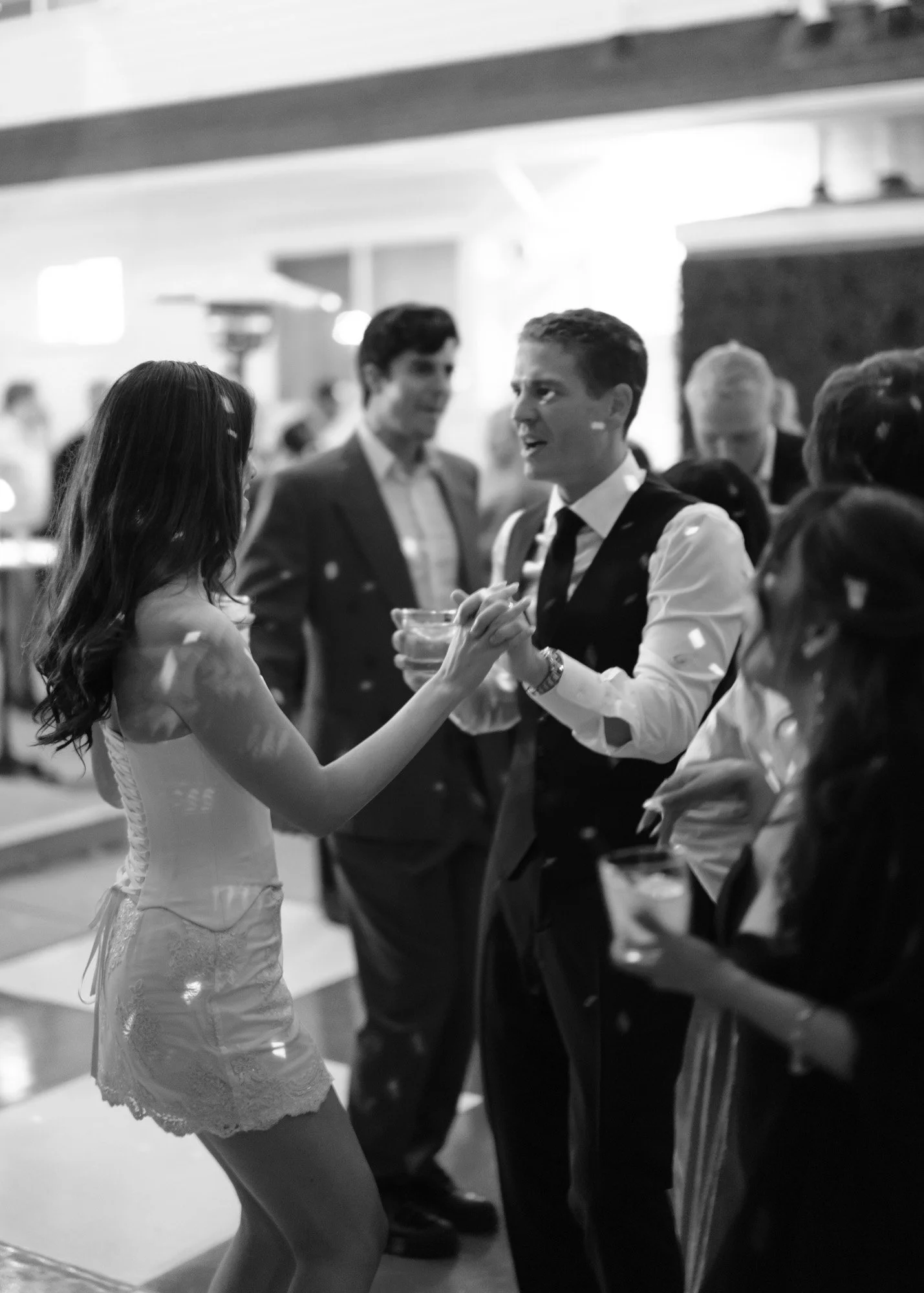 Black and white candid bride and groom dancing during a documentary wedding reception