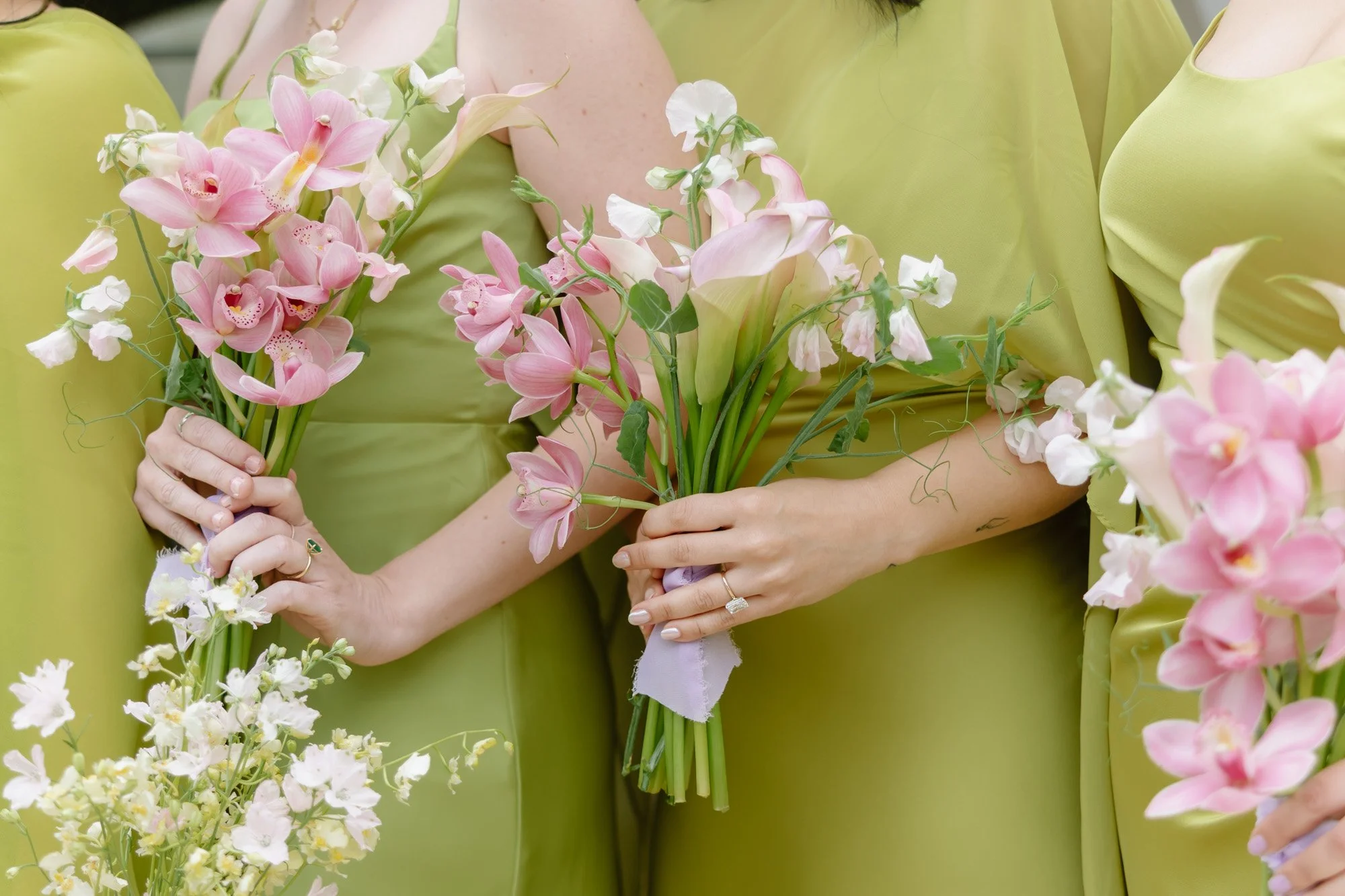 Bridesmaid holding pink orchid and calla lily bouquet at an editorial California wedding