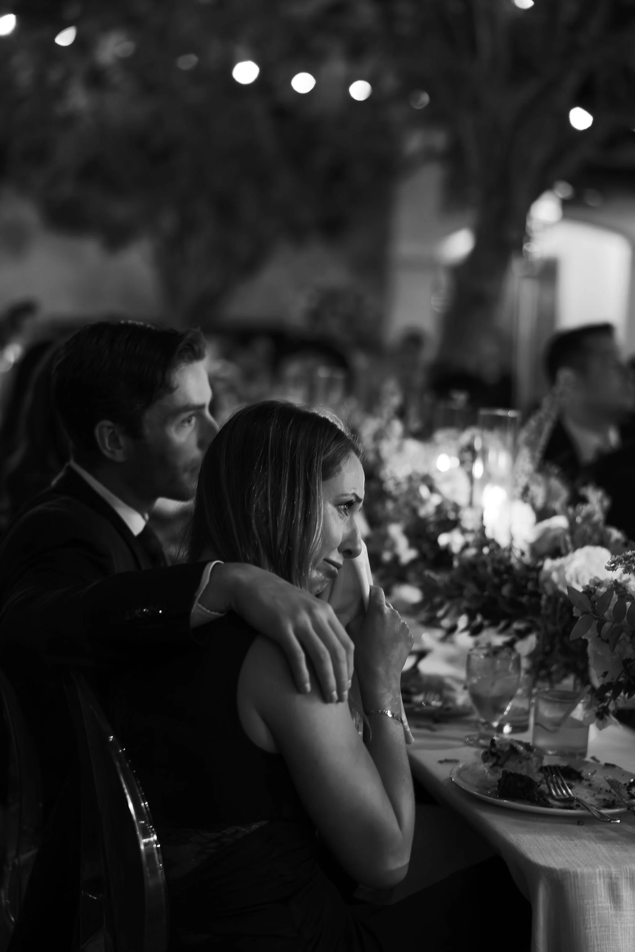Black and white candid dinner moment at a documentary-style wedding reception