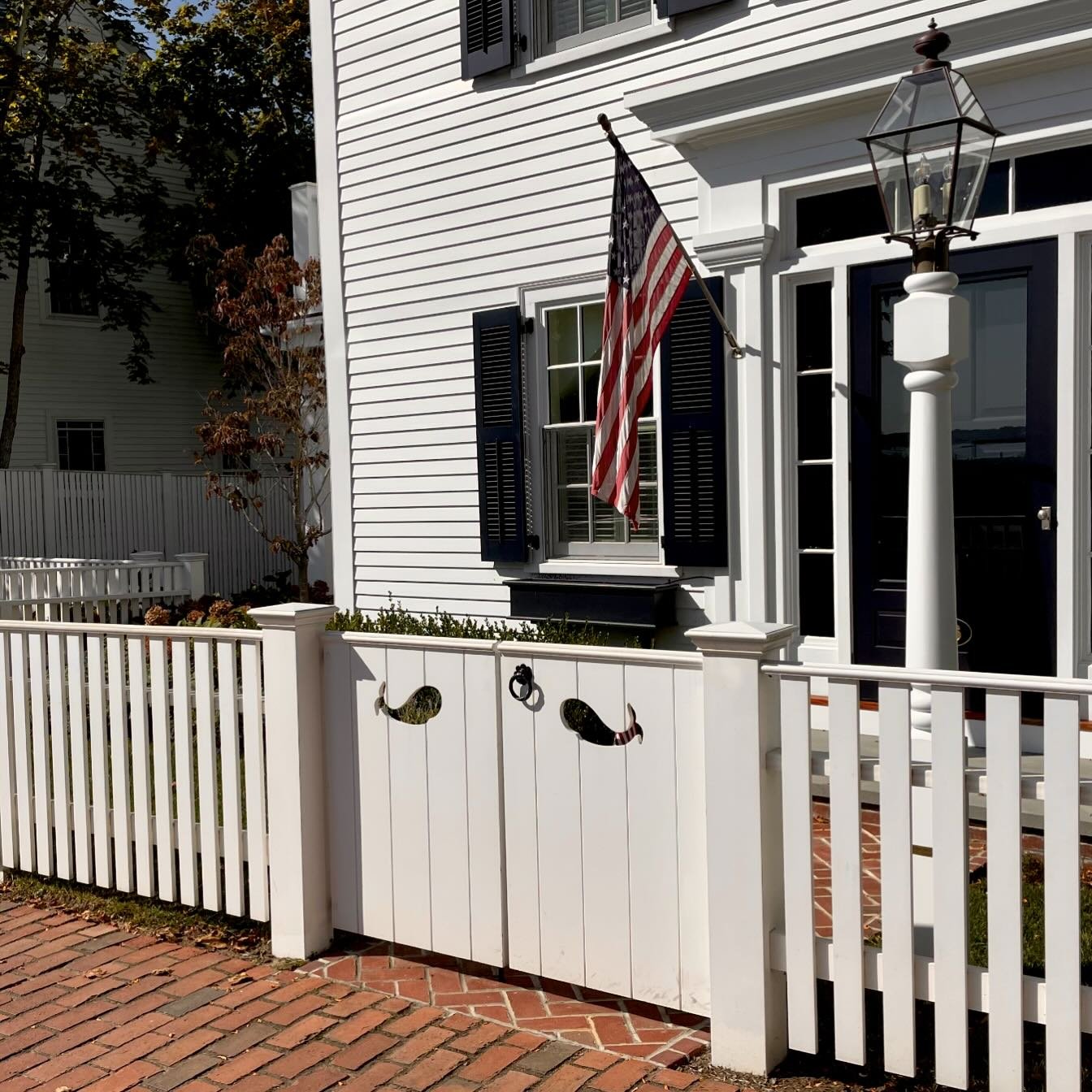 While taking a stroll down this historic street you just might see whales! A traditional Edgartown style picket fence and solid gates with decorative cutouts. #perfectionfence #fence #fences #fencebuilder #fencesofinstagram #design #gate #entrygate #