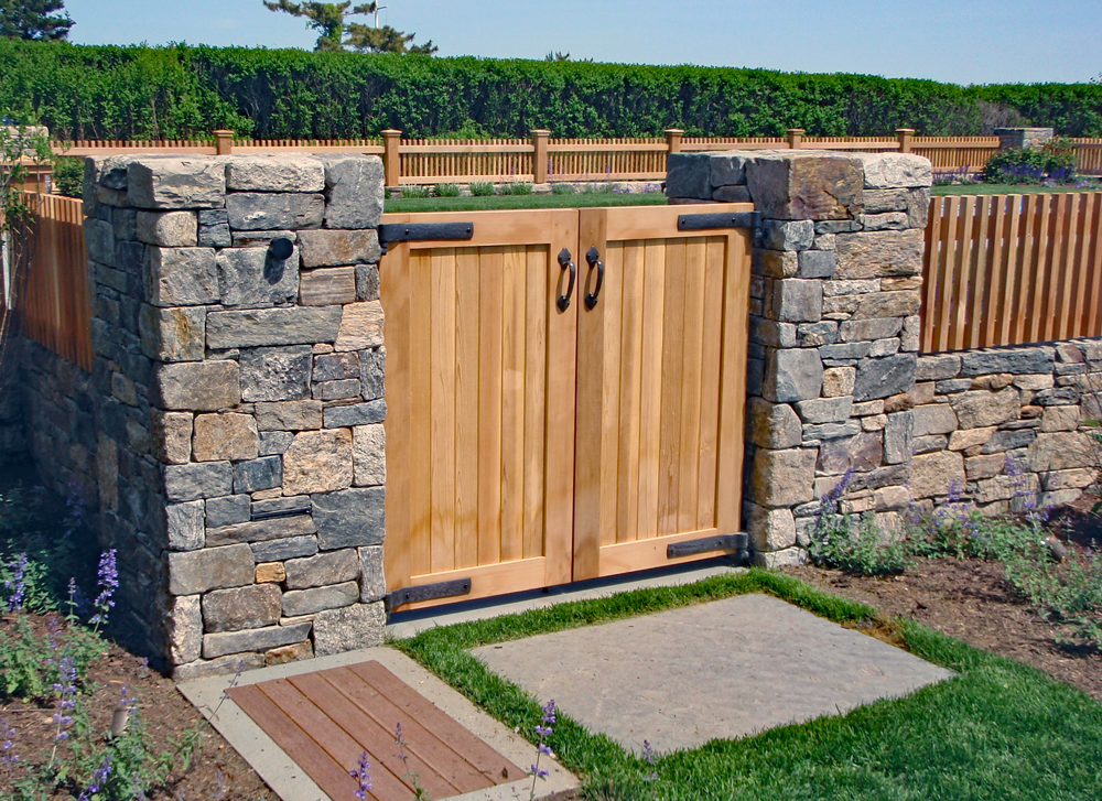 Cedar Entry Gate G-5:

Wood is still a respected material for construction. Using exceptional quality woods extends the life and beauty over years. For the quality required, we used clear western red cedar with radius corners on the frame and bronze 