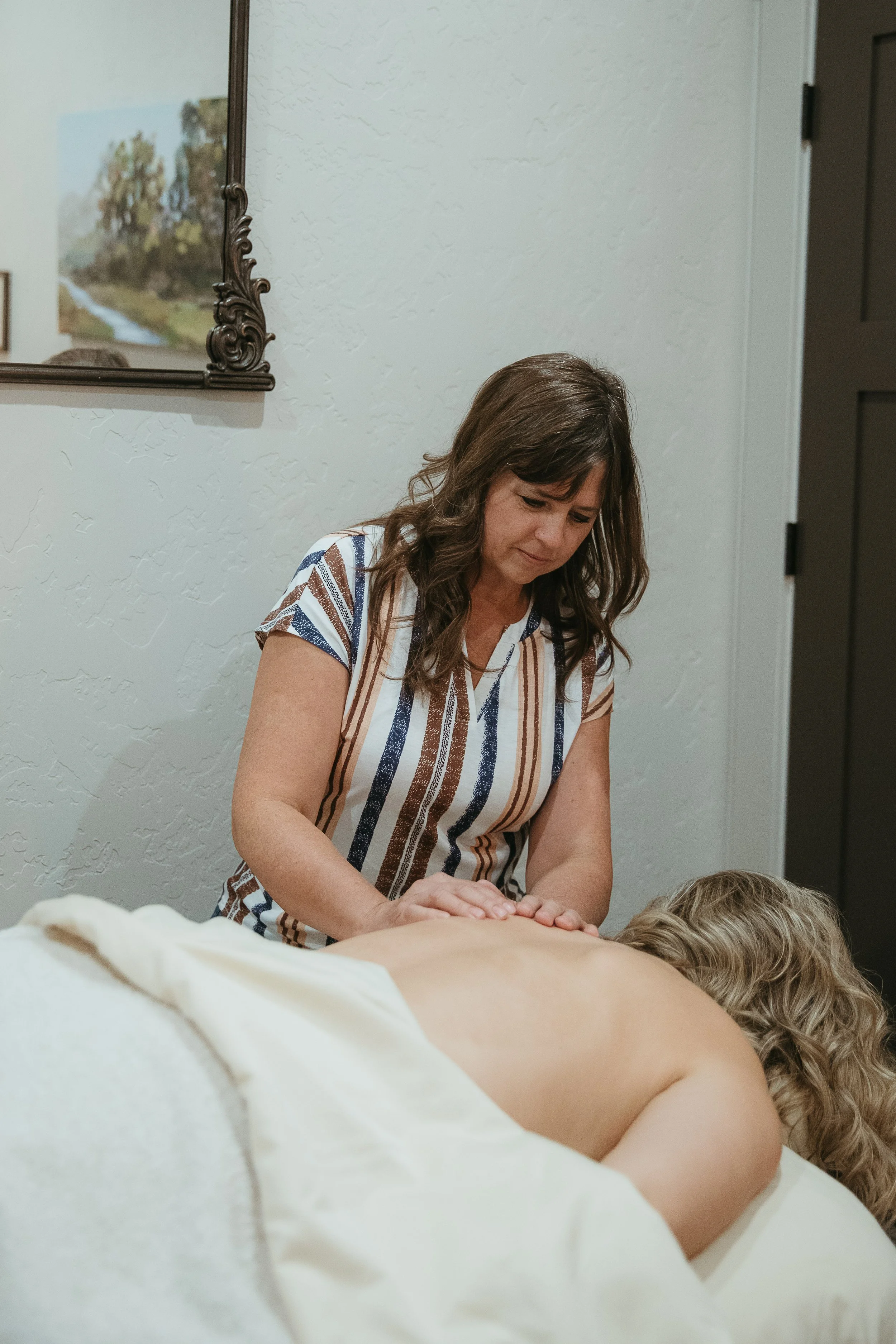 Rachel Hines providing gentle hands-on bodywork for an adult client at Rounded Care.