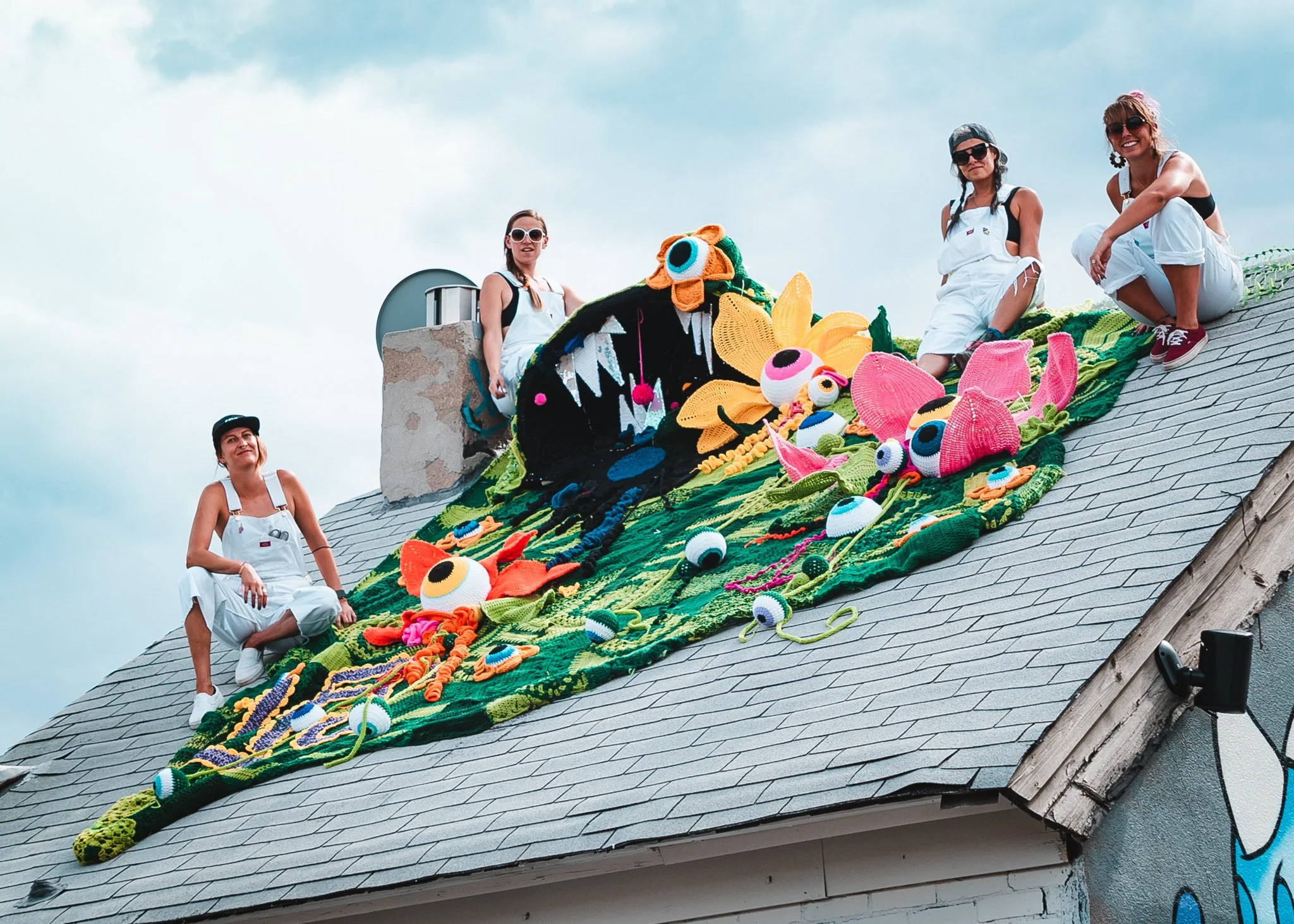 Ladies Fancywork Society members with soft sculpture on rooftop