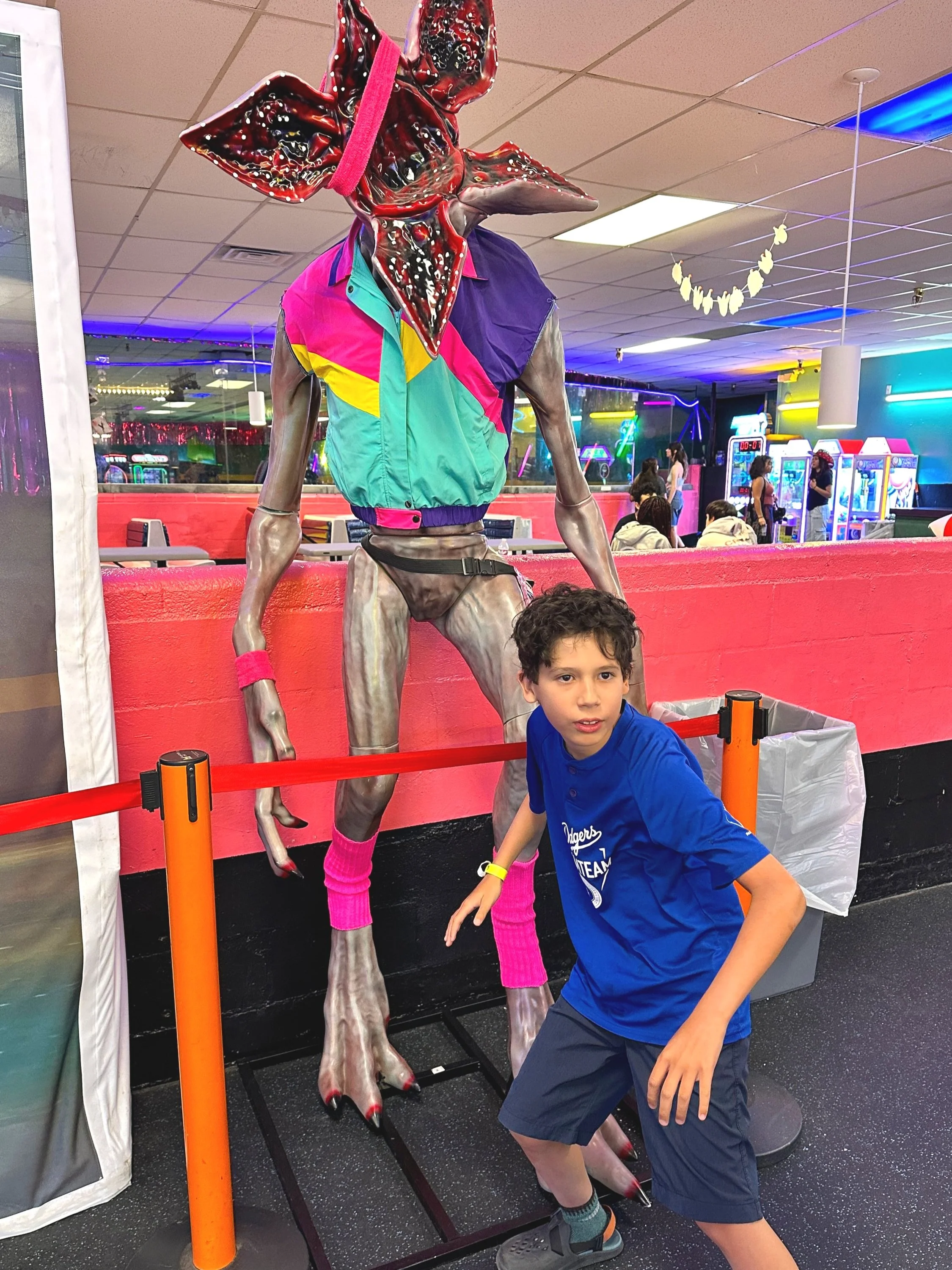My son with a life-size demogorgon from Stranger Things.