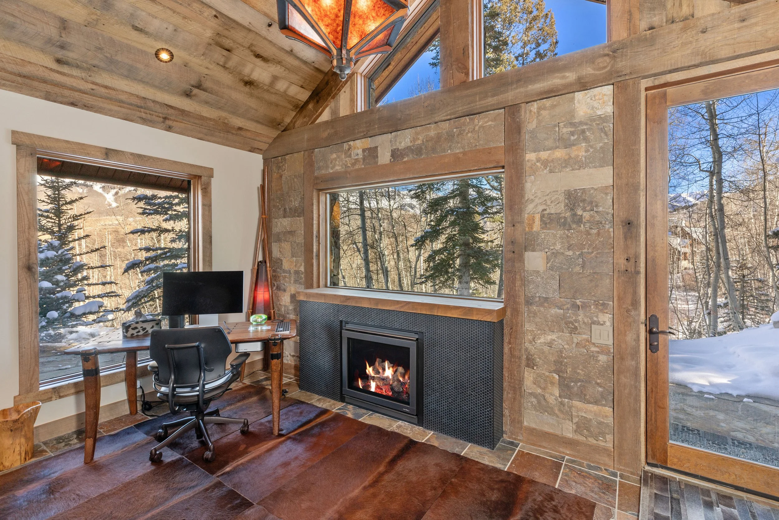 Custom home office with stone fireplace and mountain views, Telluride, Colorado remodel.