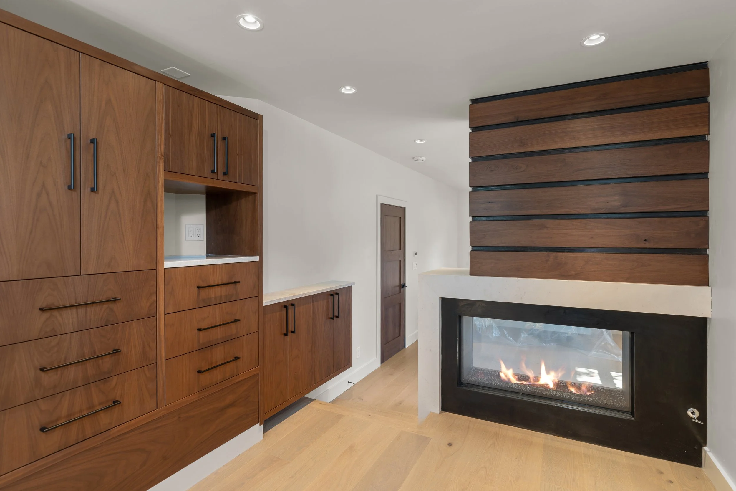 Custom walnut cabinetry with slatted wood fireplace surround, Telluride, Colorado home
