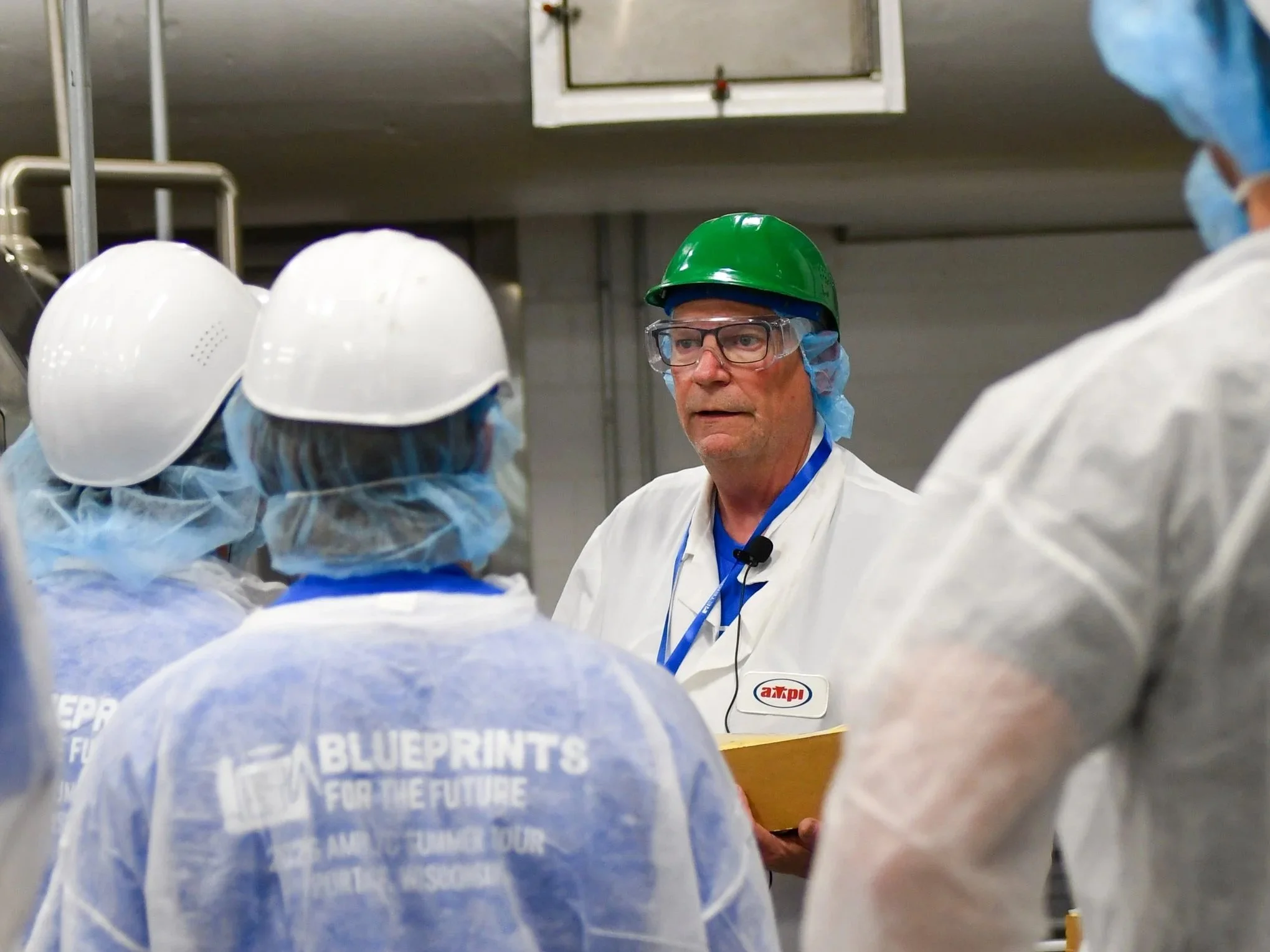   Plant operations manager Mike Clemmons leads YCs on a tour of the newly rebuilt Portage plant. The co-op’s only consumer-packaged cheese plant specializes in products for foodservice customers, including American cheese slices and loaves, and natur