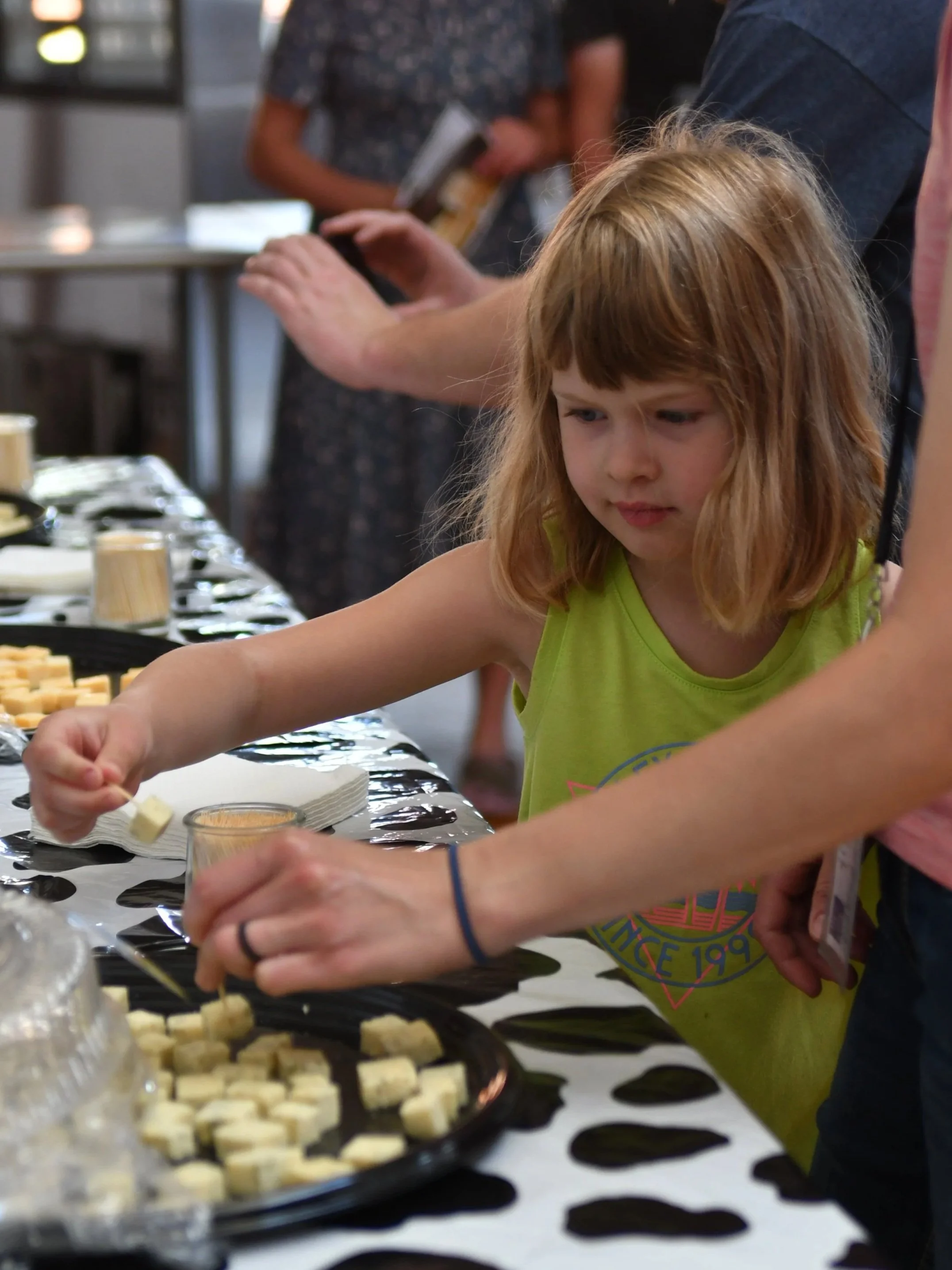   Ellie Golombeski, daughter of Jake and Angie Golombeski of Morristown, Minn., samples AMPI-made cheese during a visit to the Hoard’s Dairyman office.  
