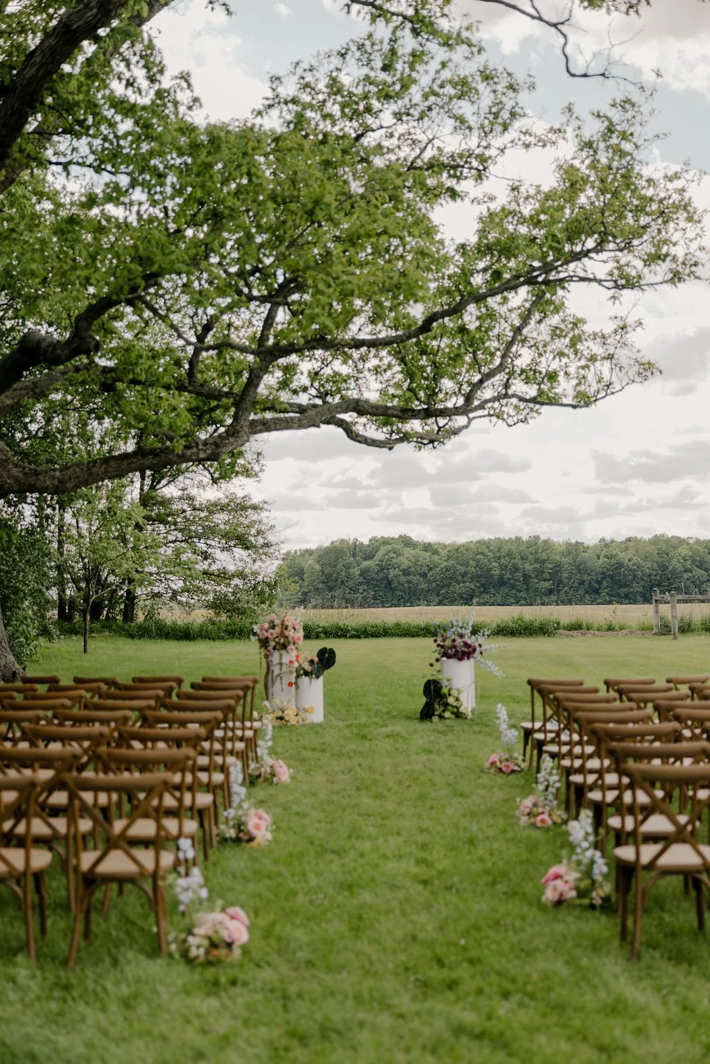 Outdoor ceremony setup beneath the historic oak tree at Aspen & Alston wedding venue