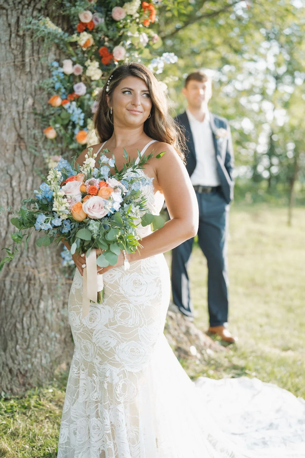 Bride holding bouquet beside the oak tree ceremony space at Aspen & Alston wedding venue in Ohio