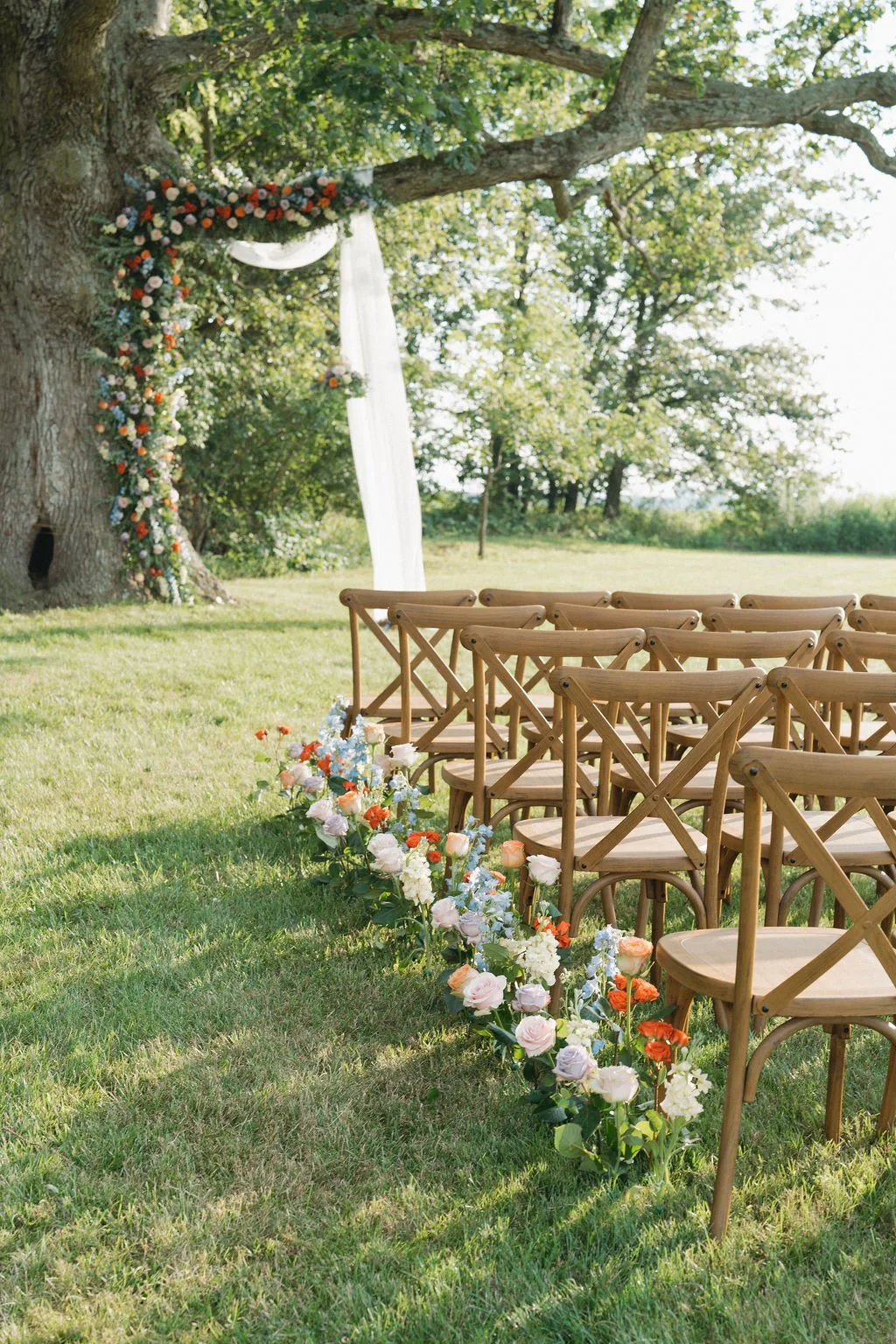 Outdoor wedding ceremony chairs beneath the oak tree at Aspen & Alston wedding venue in Ohio