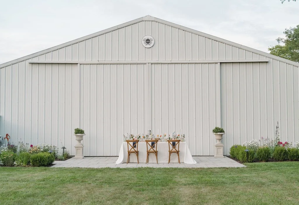 Styled table setup outside the vintage barn at Aspen & Alston wedding venue